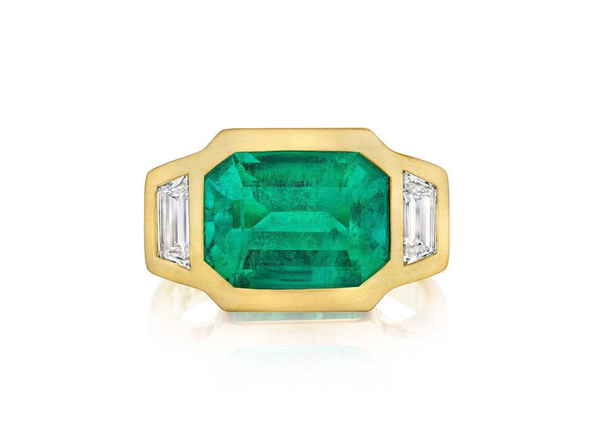 Bezel Set East-West Emerald Cut Emerald Three Stone Ring with Trapezoid Diamond Side Stones in Matte Yellow Gold