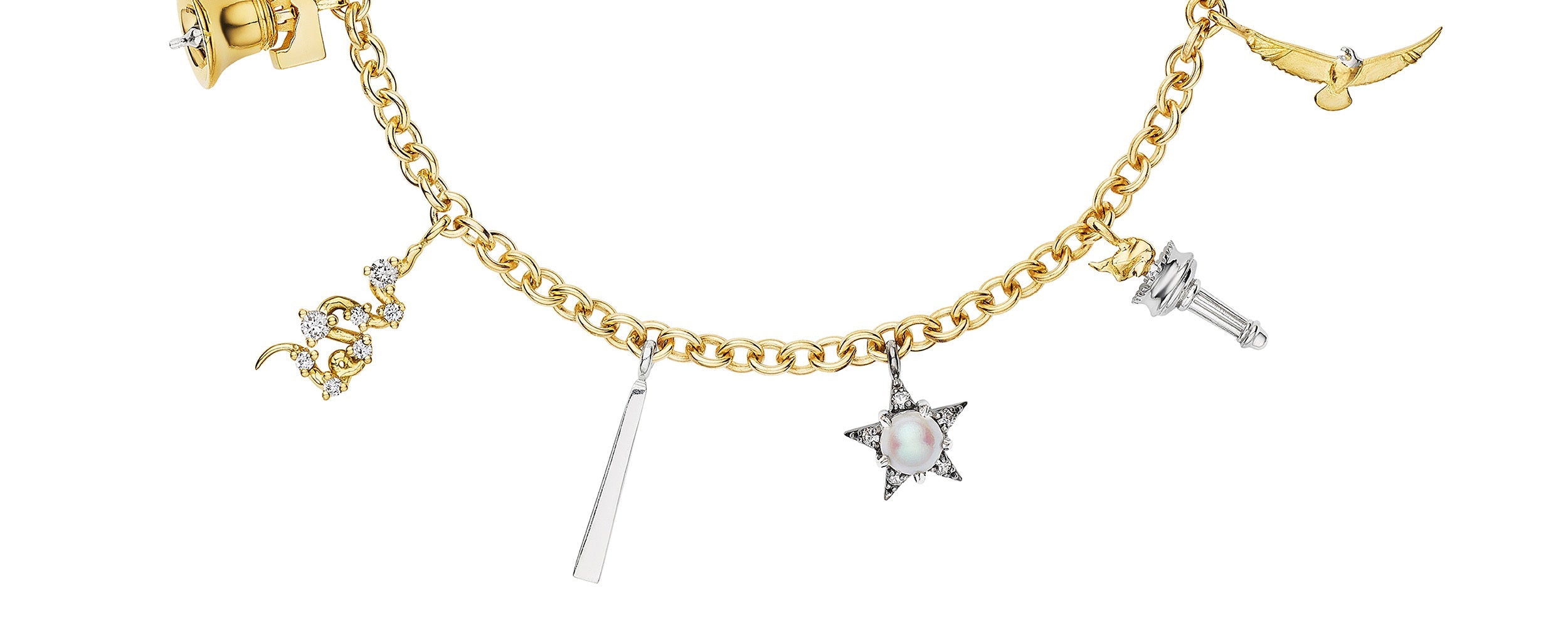 A gold chain bracelet featuring nine unique charms, including gemstones, a bell, a star, a hand, a bird, a pyramid, and various other symbolic shapes, each in gold or silver tones.
