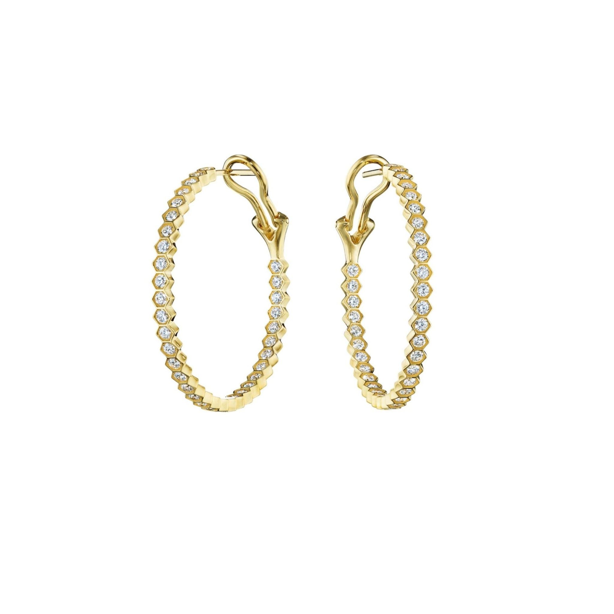 A pair of gold hoop earrings encrusted with small round diamonds, featuring secure hinged clasps, displayed on a white background.