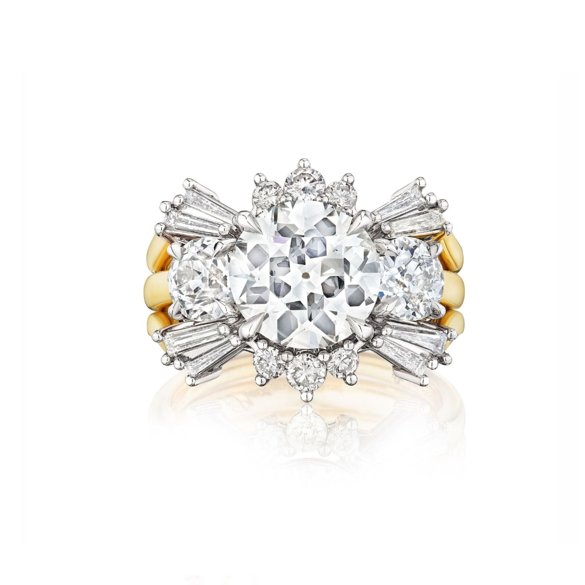 A gold ring featuring a large round center diamond, flanked by two smaller round diamonds and surrounded by tapered baguette and round accent diamonds in a floral-inspired design.