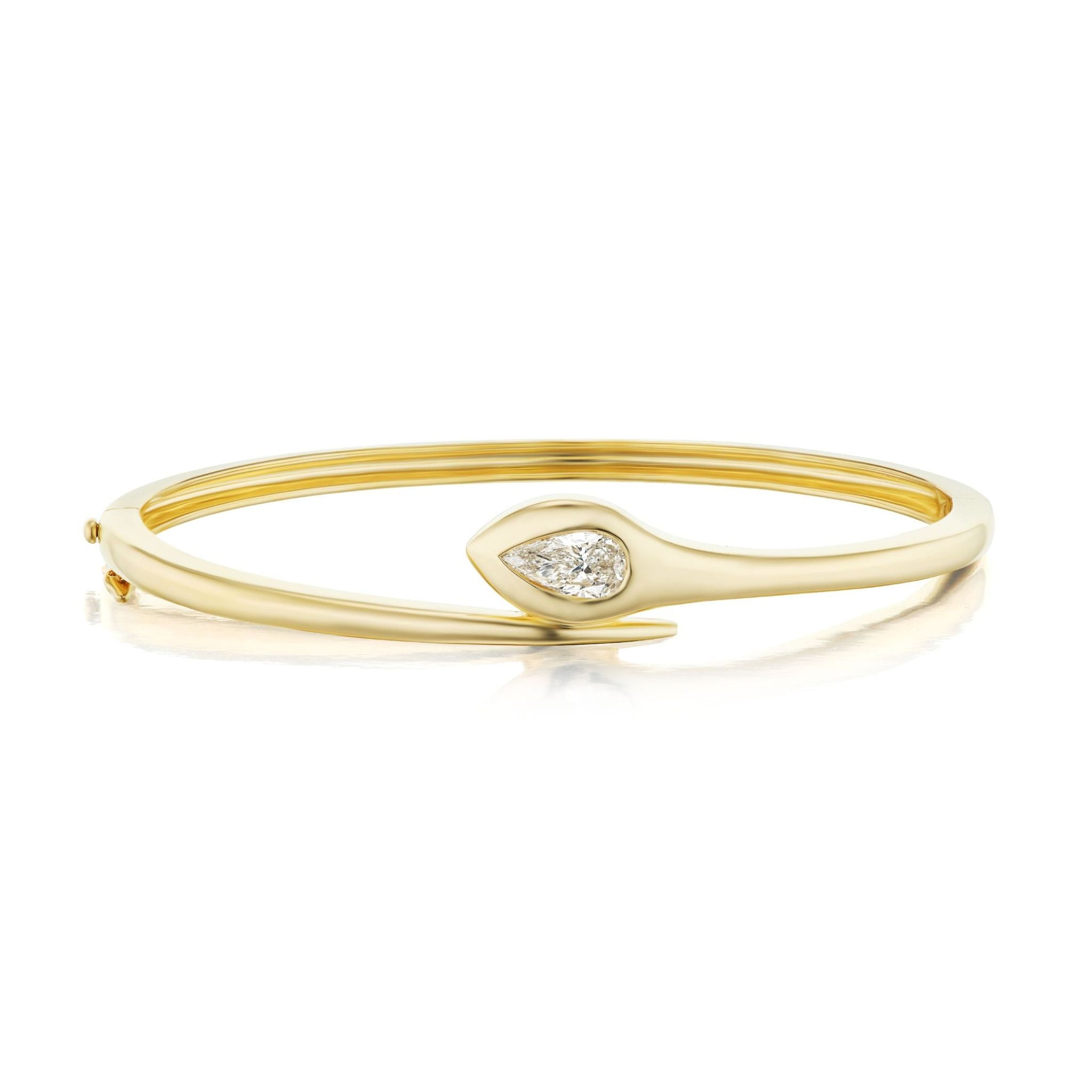 A gold bangle bracelet with a sleek, modern design featuring a marquise-shaped diamond set at the center, resembling an abstract eye or leaf form.