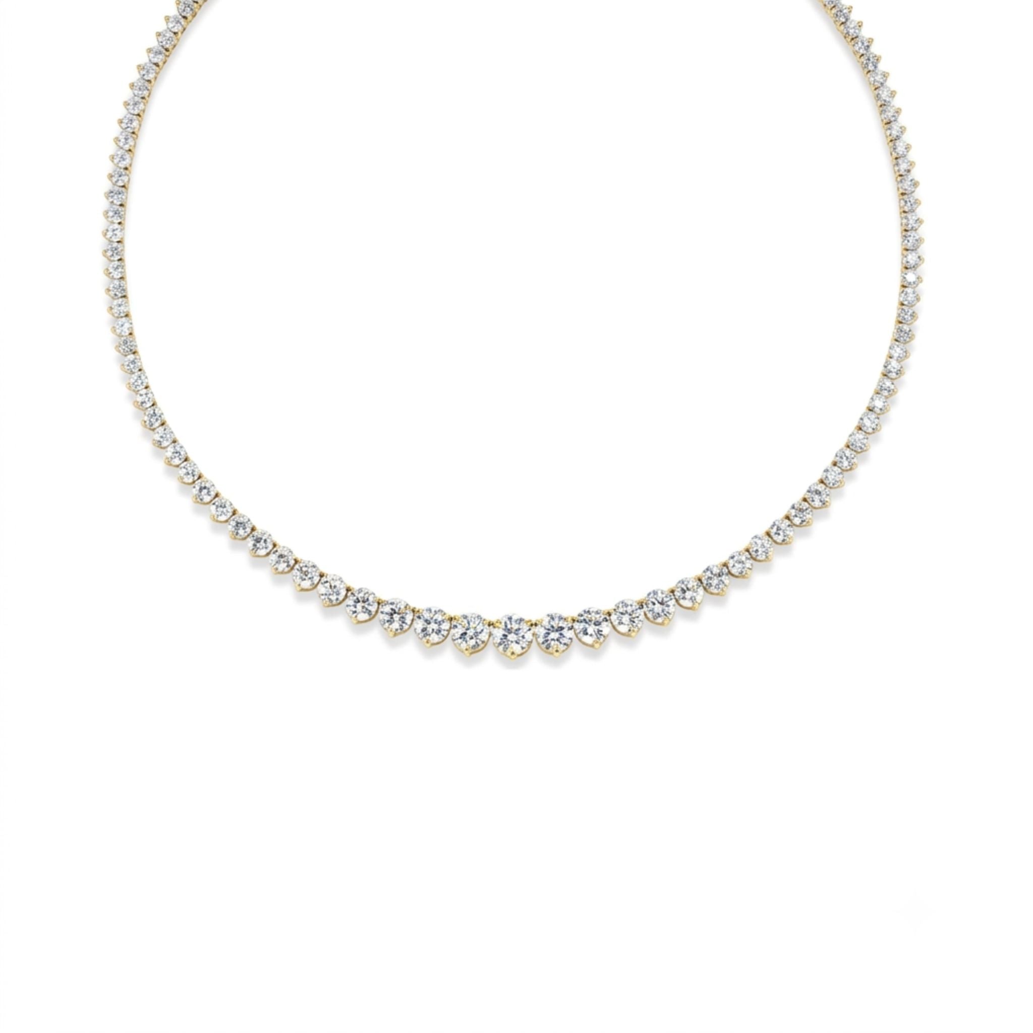 A delicate tennis necklace featuring a continuous line of round white diamonds set in a thin metal chain, displayed in a circular shape on a white background.