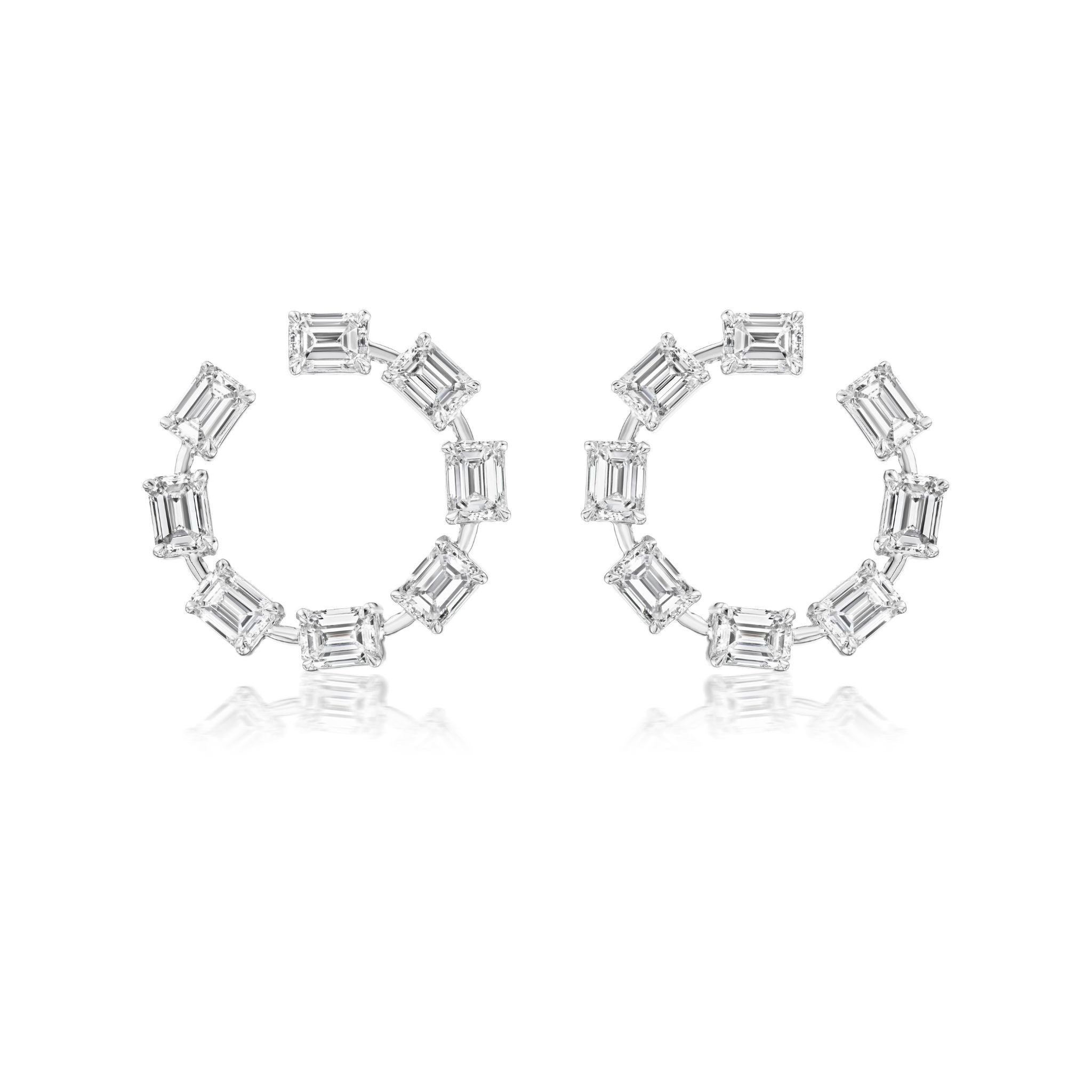 A pair of elegant, silver earrings with a marquise-shaped central gem, crisscrossed bands, and multiple smaller round and baguette-cut stones arranged in a stylish, symmetrical design.