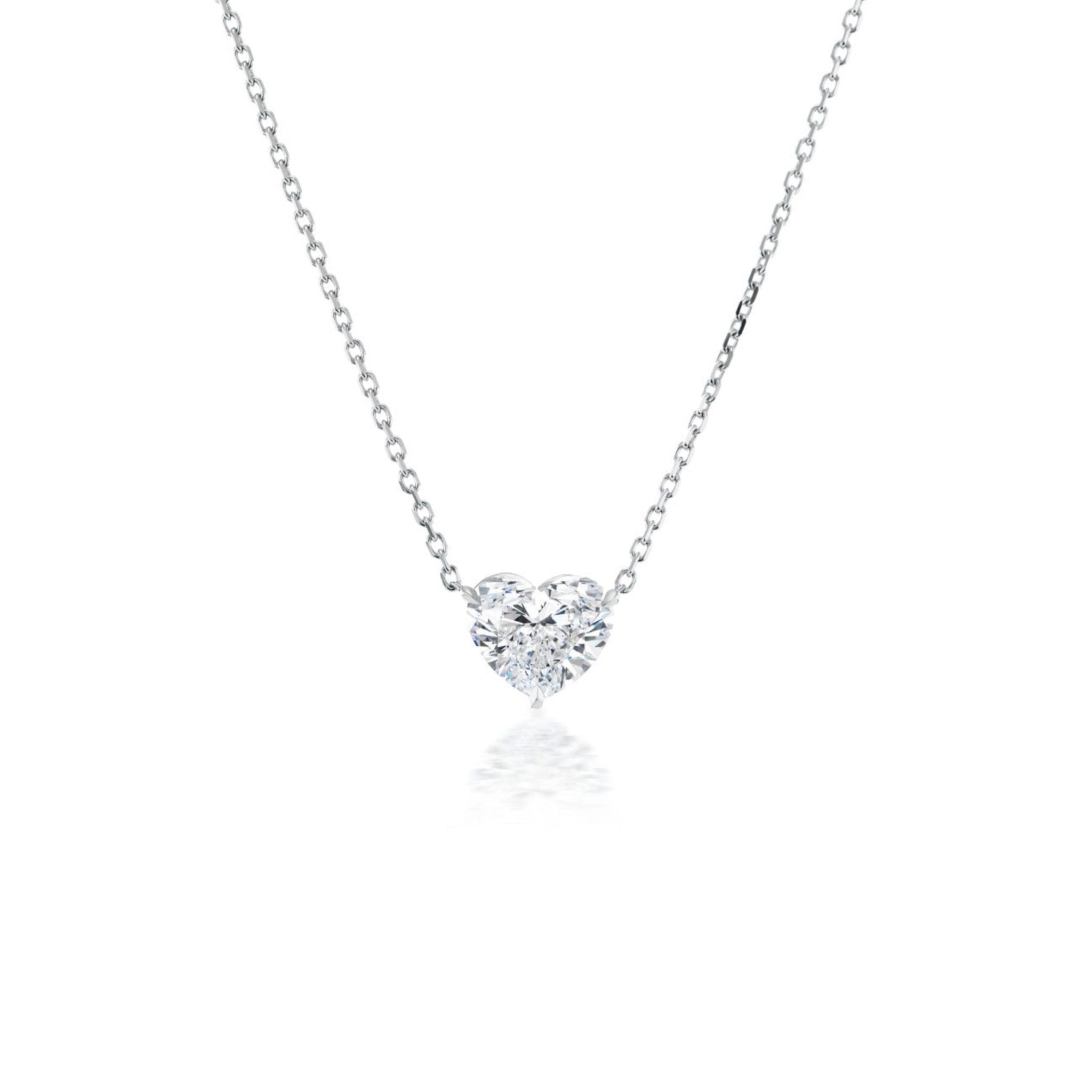 A delicate silver chain necklace featuring a sparkling heart-shaped diamond pendant centered against a white background.