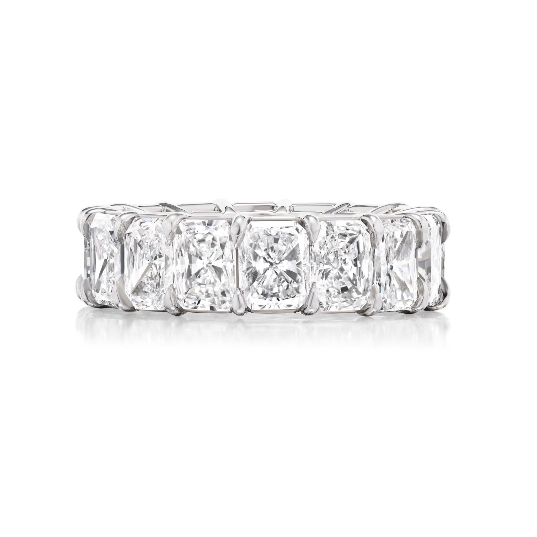 A platinum eternity band set with large, rectangular cushion-cut diamonds all around, displayed on a white background.
