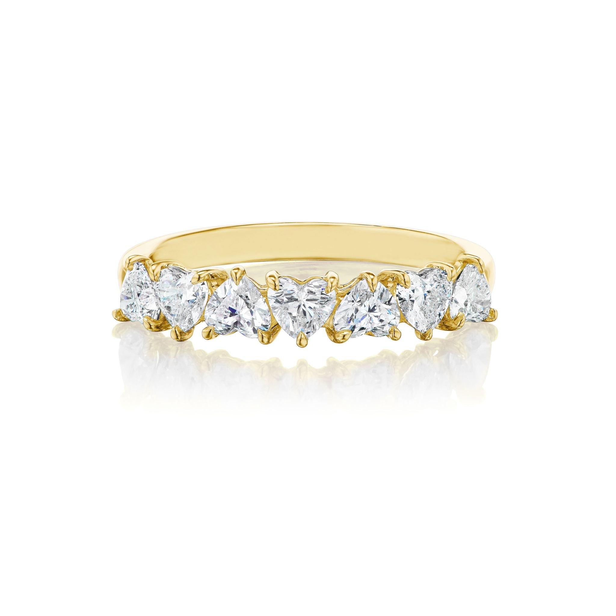 A gold ring set with seven heart-shaped clear gemstones arranged in a row, displayed on a white background.