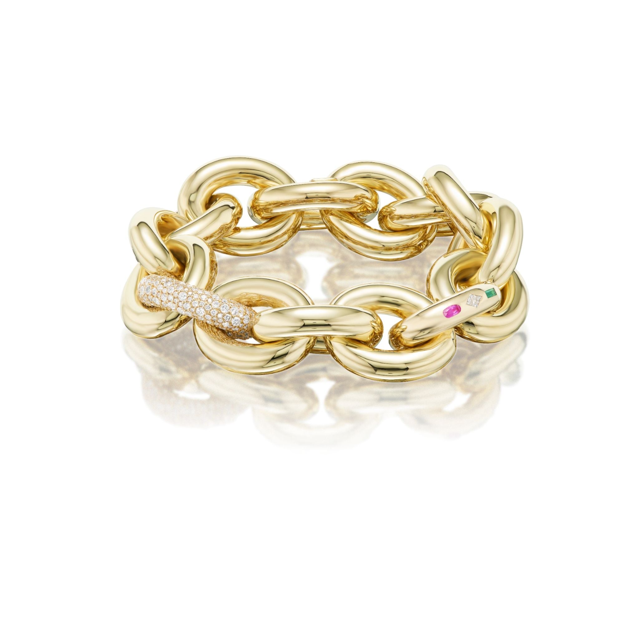 A chunky gold chain bracelet featuring oval links, one adorned with small white diamonds and another with a pink gemstone and small green gemstone. The bracelet is shown on a white background.