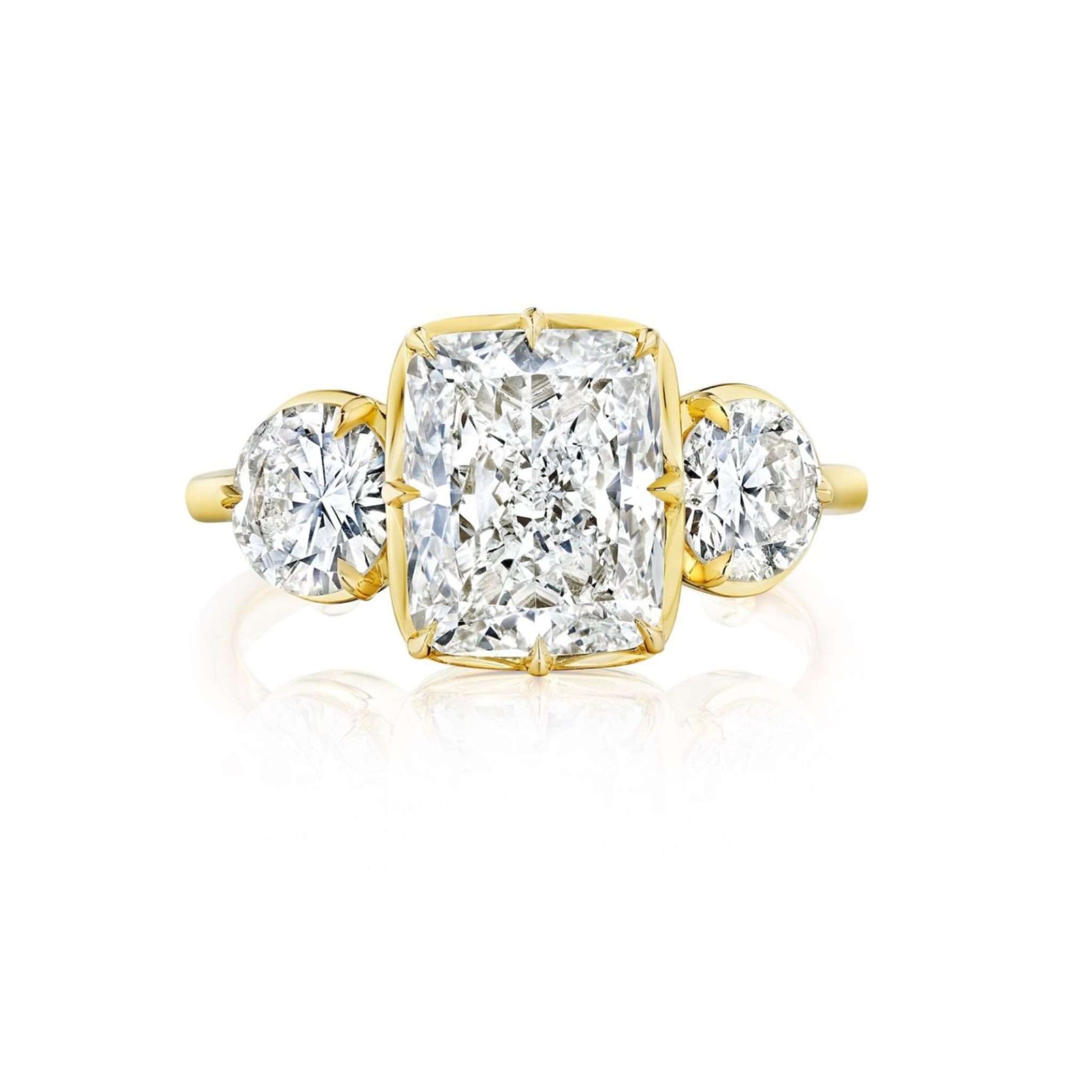A platinum ring featuring a large emerald-cut diamond center stone, flanked by step-set tapered baguette diamonds on each side, displayed on a white background.