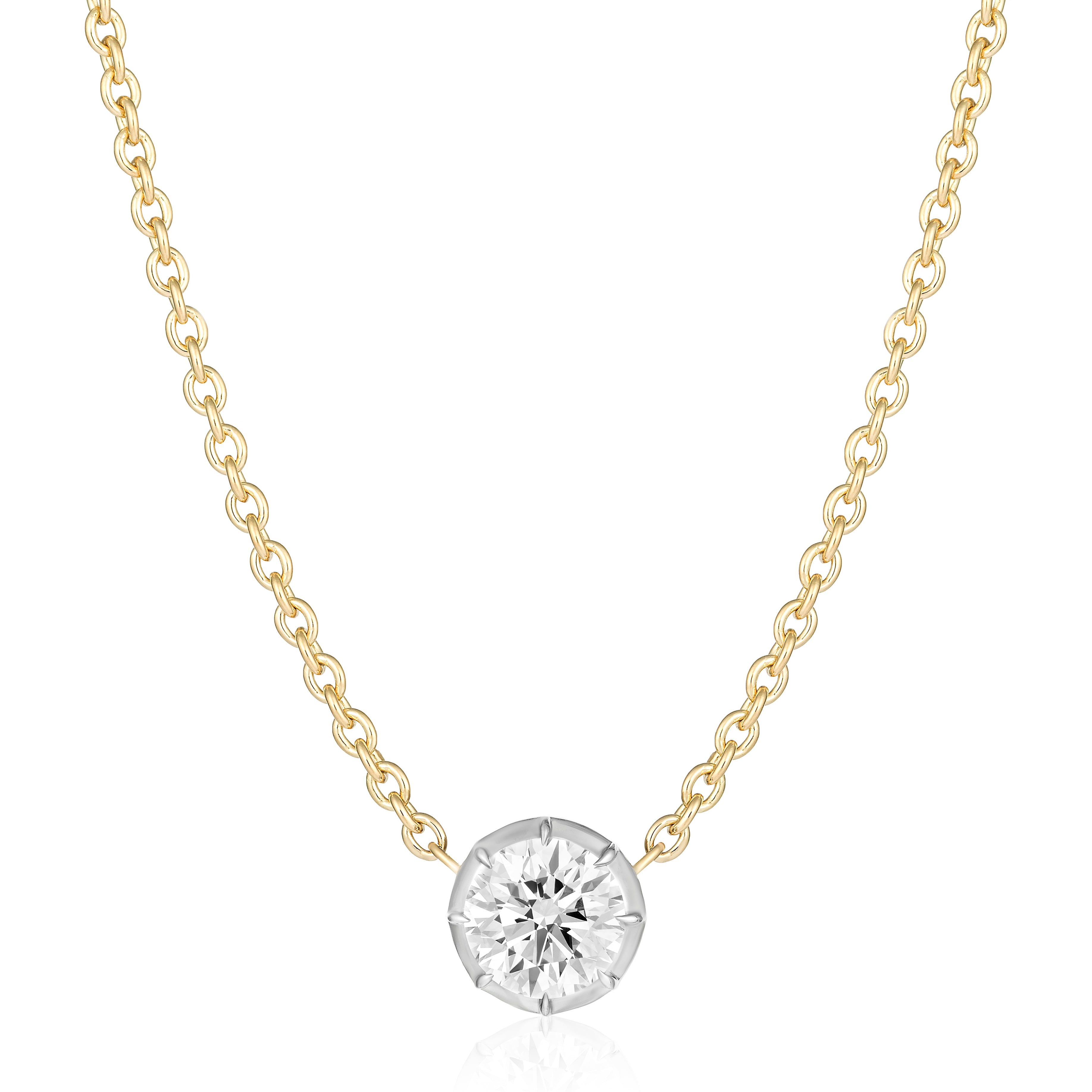 The Collet Set Round Diamond Pendant in White and Yellow Gold features a single round brilliant diamond in a minimalist bezel setting, showcased on a white background.