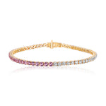The This & That Round Brilliant Diamond and Pink Sapphire Tennis Bracelet in 18k yellow gold features a secure clasp and round gemstones that shift from pink and purple to clear diamonds, shown on a white background.