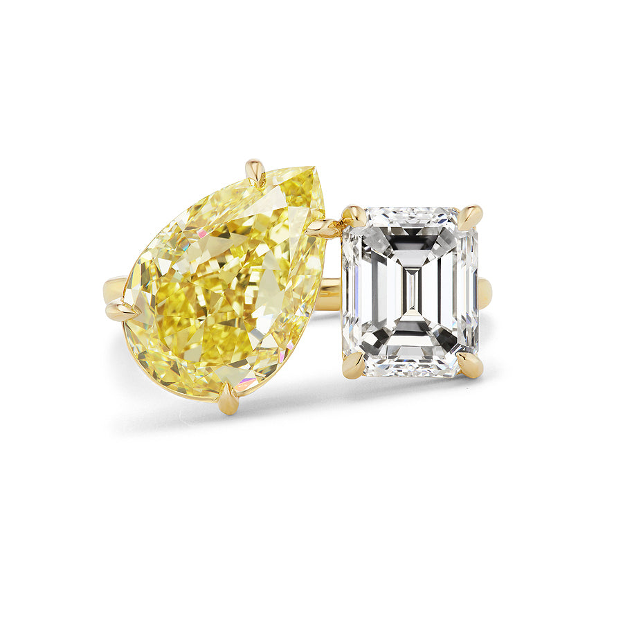 The Toi et Moi Ring features a large pear-shaped fancy yellow diamond and an emerald-cut white diamond, both set in prongs.