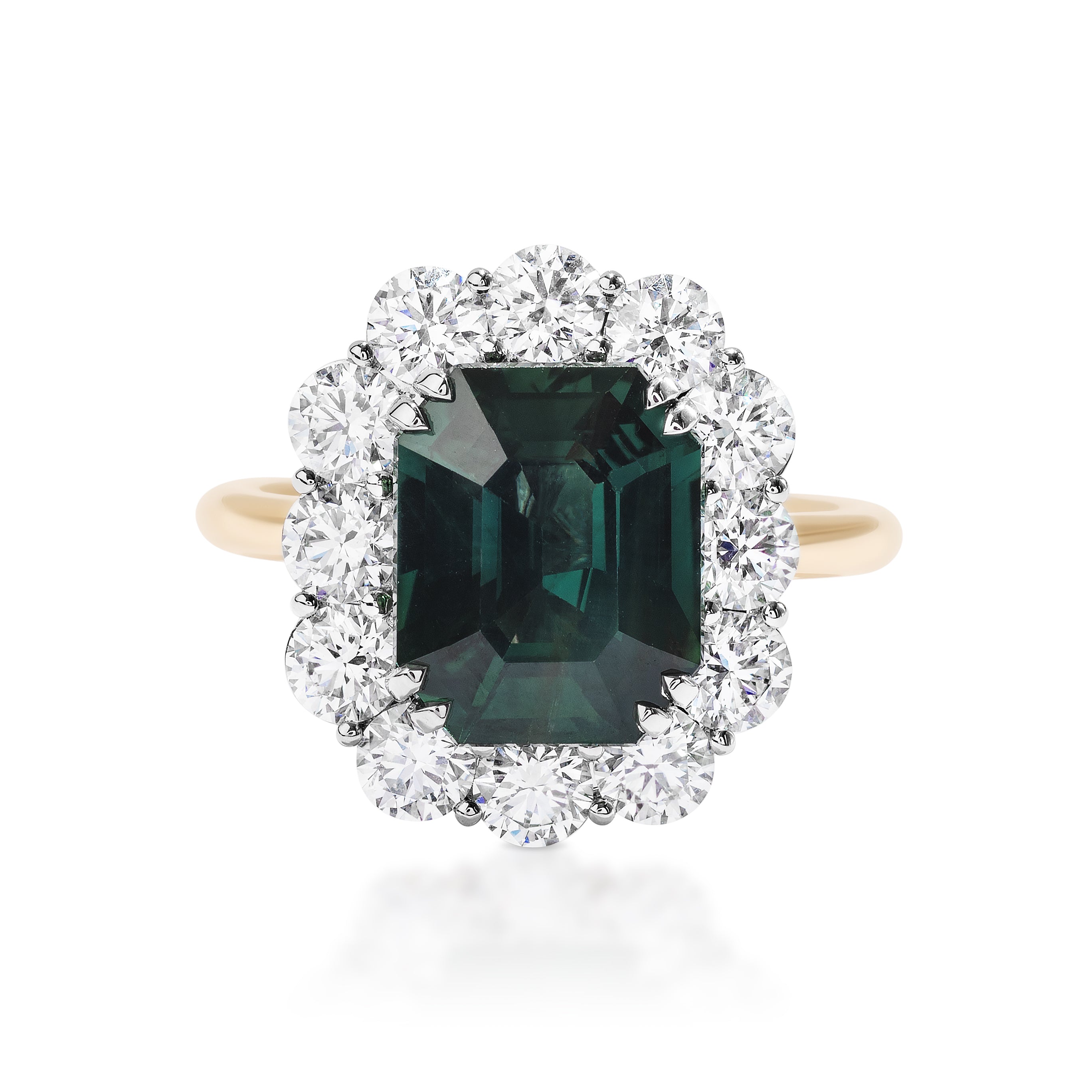 The Elongated Asscher Cut Sapphire Engagement Ring features a vibrant green sapphire center in 18K yellow gold, accented by a halo of round sparkling white diamonds.