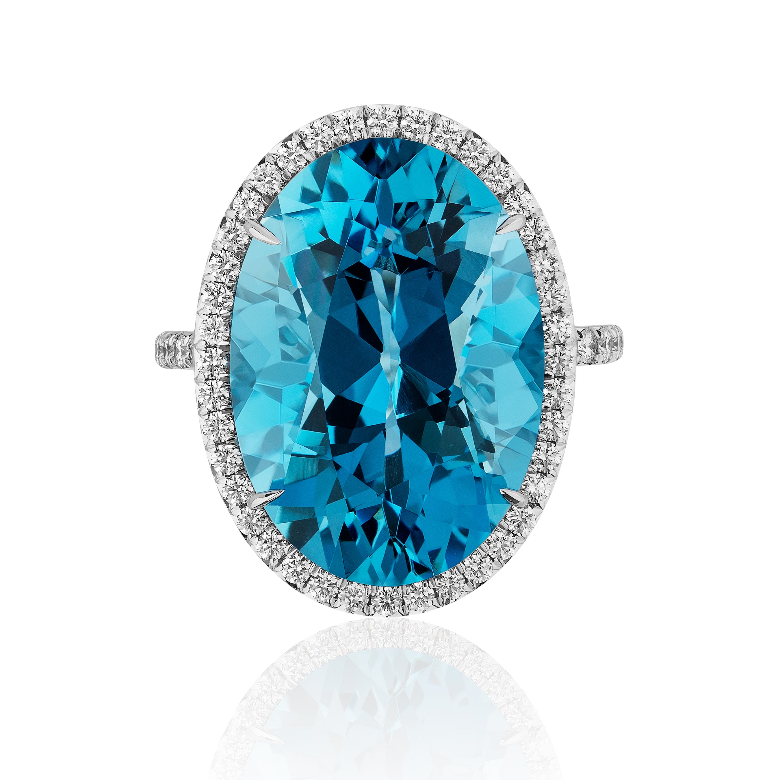 The Oval Aquamarine Ring with Diamond Halo and Pavé Band features a large oval aquamarine set in 18K white gold, surrounded by a halo of round white diamonds, displayed against a white background.