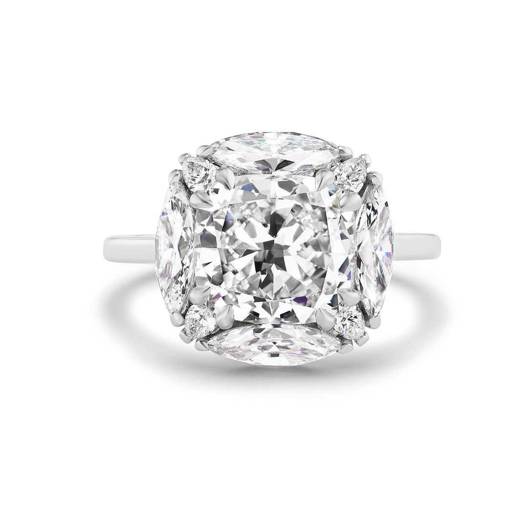 The Cushion Cut Diamond Engagement Ring with Marquise and Pear Diamond Halo showcases a striking cushion-cut center, surrounded by marquise and pear diamonds—a dazzling pick for bridal jewelry.
