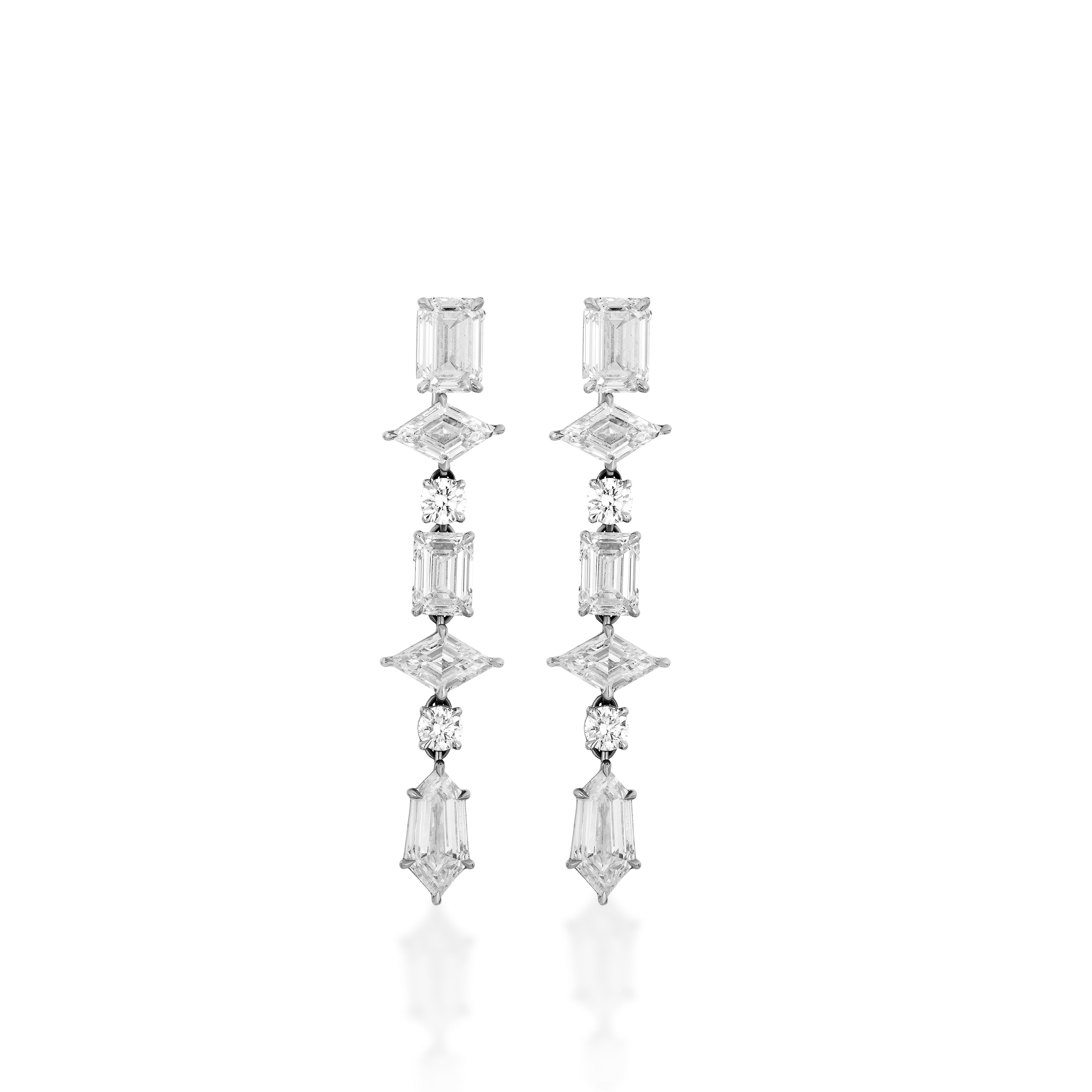 The Mixed Shape Tennis Ear Jackets are long, dangling earrings with clear gemstones in various shapes set vertically on 18k white gold, shown against a white background.