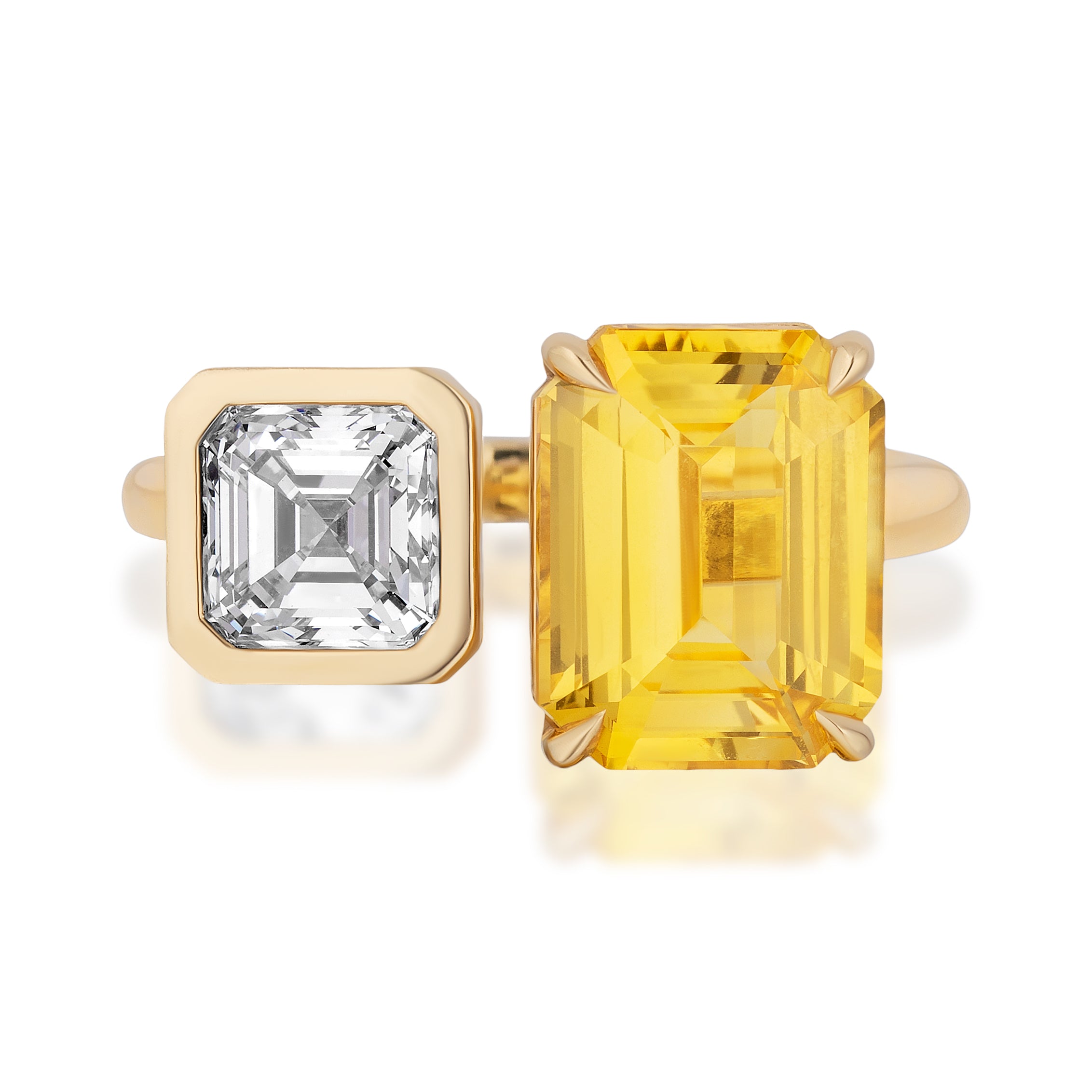 The Toi Et Moi Ring in Yellow Gold features a white Asscher cut diamond in a bezel setting and a fancy yellow emerald cut diamond in a prong setting, both set in stunning 18K yellow gold.