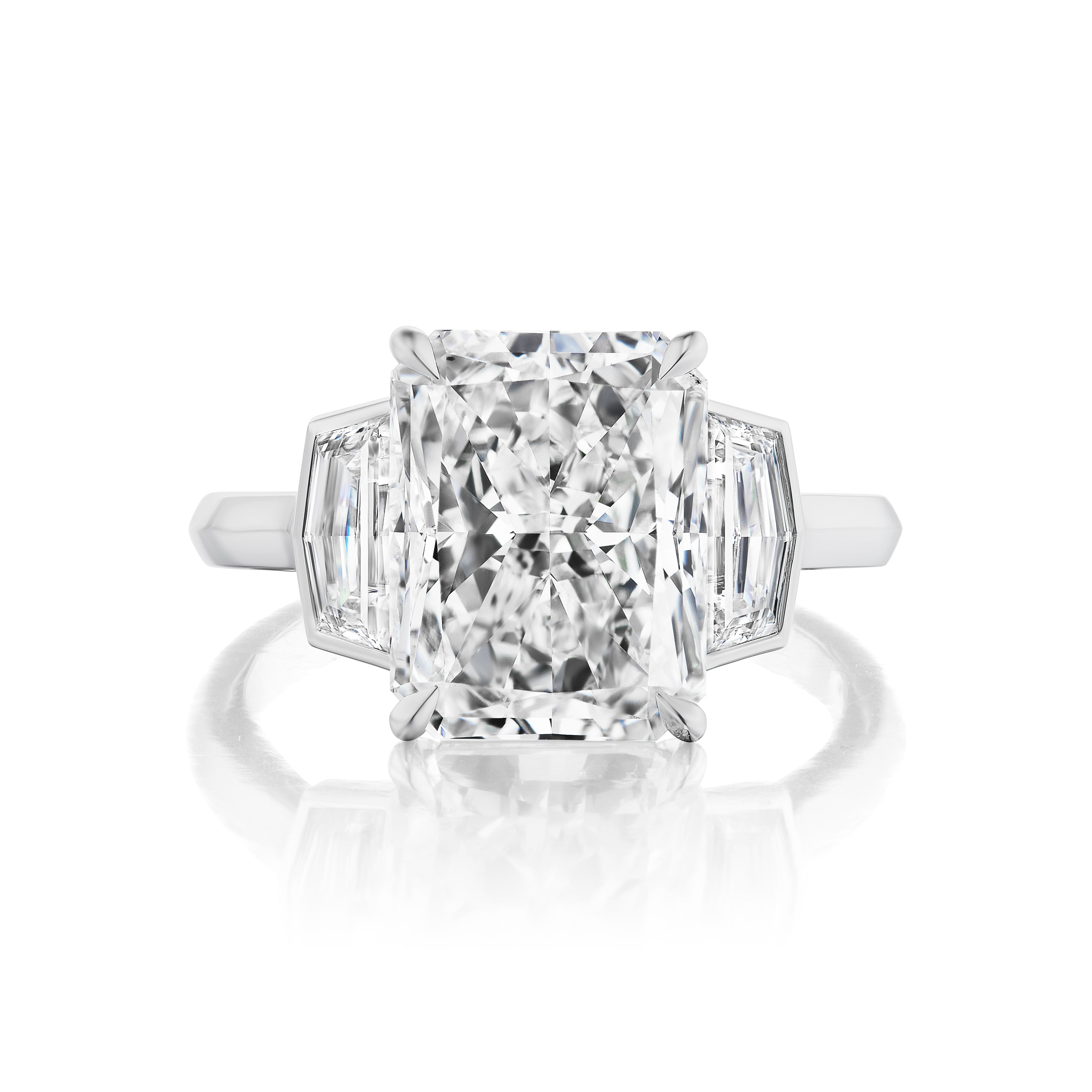 The Radiant Cut Diamond Engagement Ring features a platinum bespoke design with a large radiant-cut center stone and bezel-set epaulette side stones, shown on a white background.