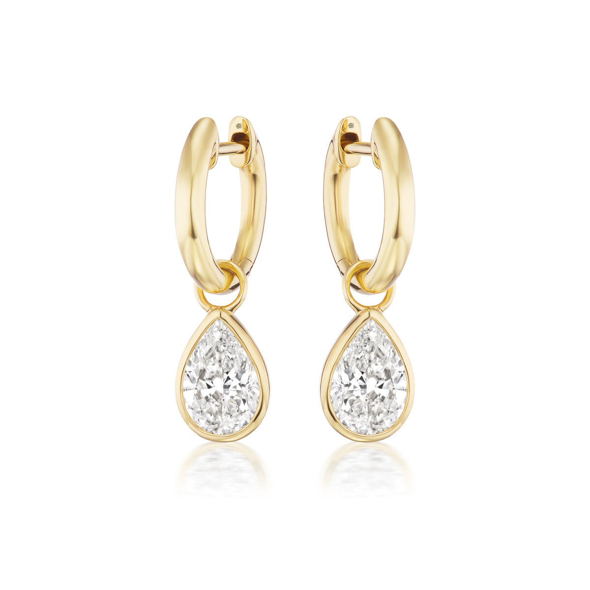 Pear Diamond Hoops: 18k yellow gold earrings with dangling SI clarity pear-shaped diamonds, shown on a white background.