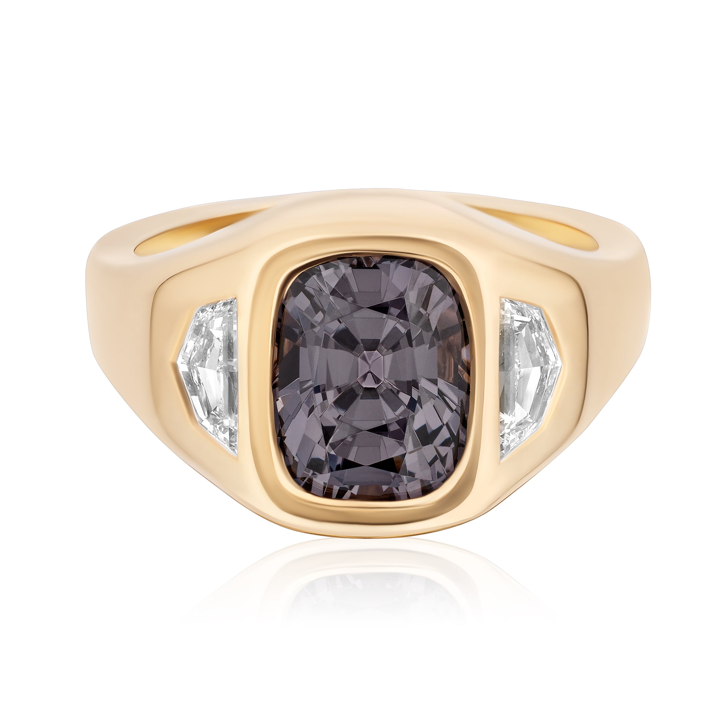 The Gypsy Ring features a cushion cut spinel center and diamond epaulette side stones, all set in a wide 18K yellow gold band.