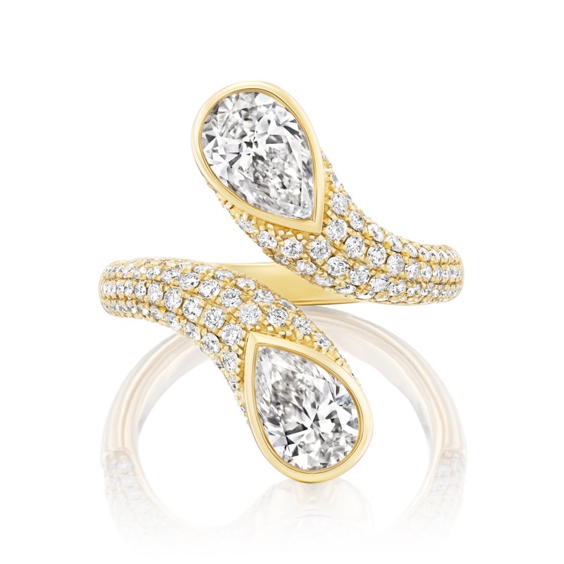 The Snake Open Space Ring in yellow gold features two pear-shaped diamonds at each end, accented by rows of smaller round diamonds along the twisted band for a sparkling, elegant look.