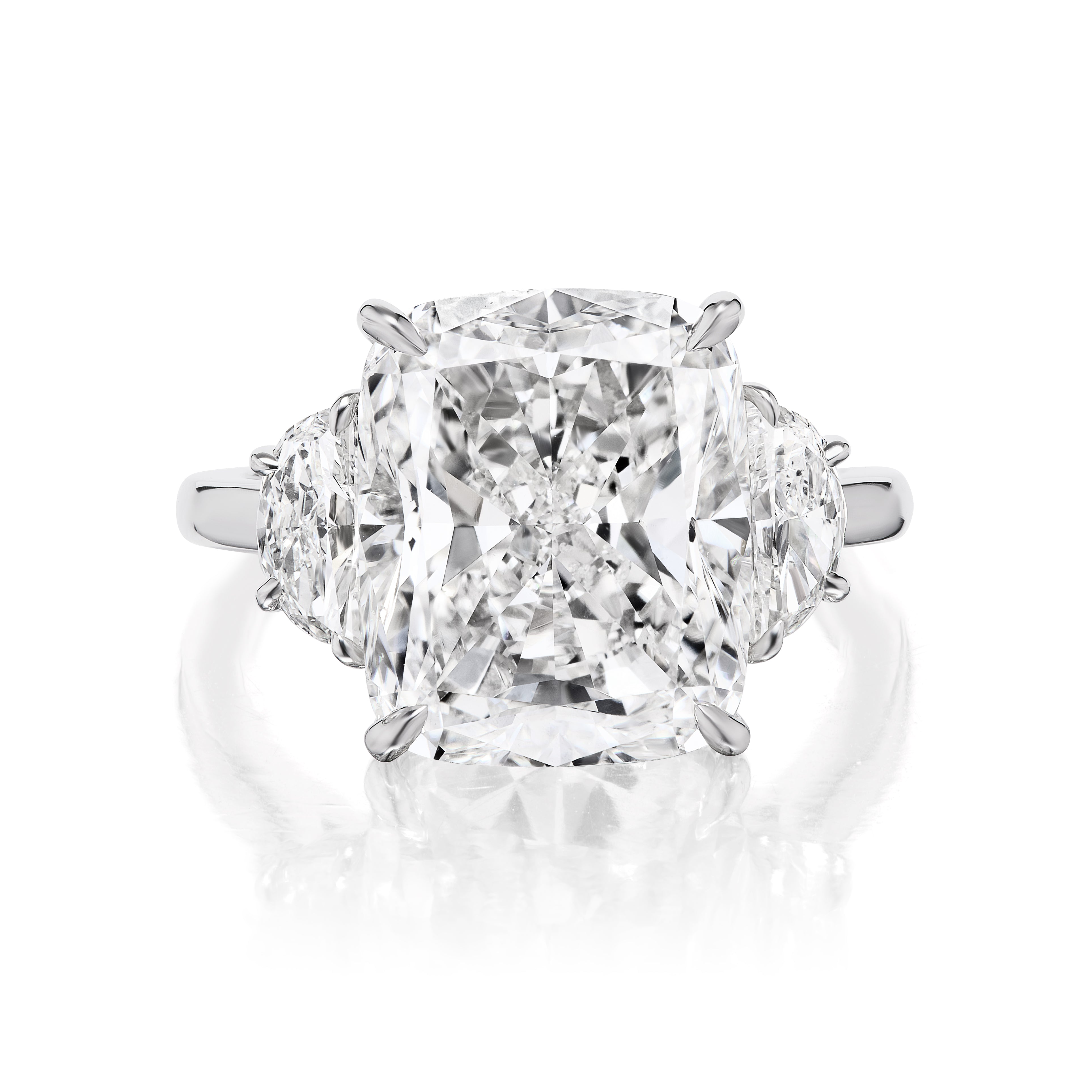 A close-up of the Cushion Cut Diamond Engagement Ring with Half Moon Side Stones, showcasing a platinum setting with a large cushion-cut center diamond and two half moon side stones in prongs.