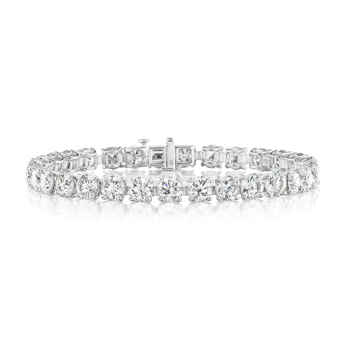 The Round Brilliant Diamond Tennis Bracelet in White Gold showcases a row of sparkling round diamonds elegantly set in white gold, displayed on a crisp white background.
