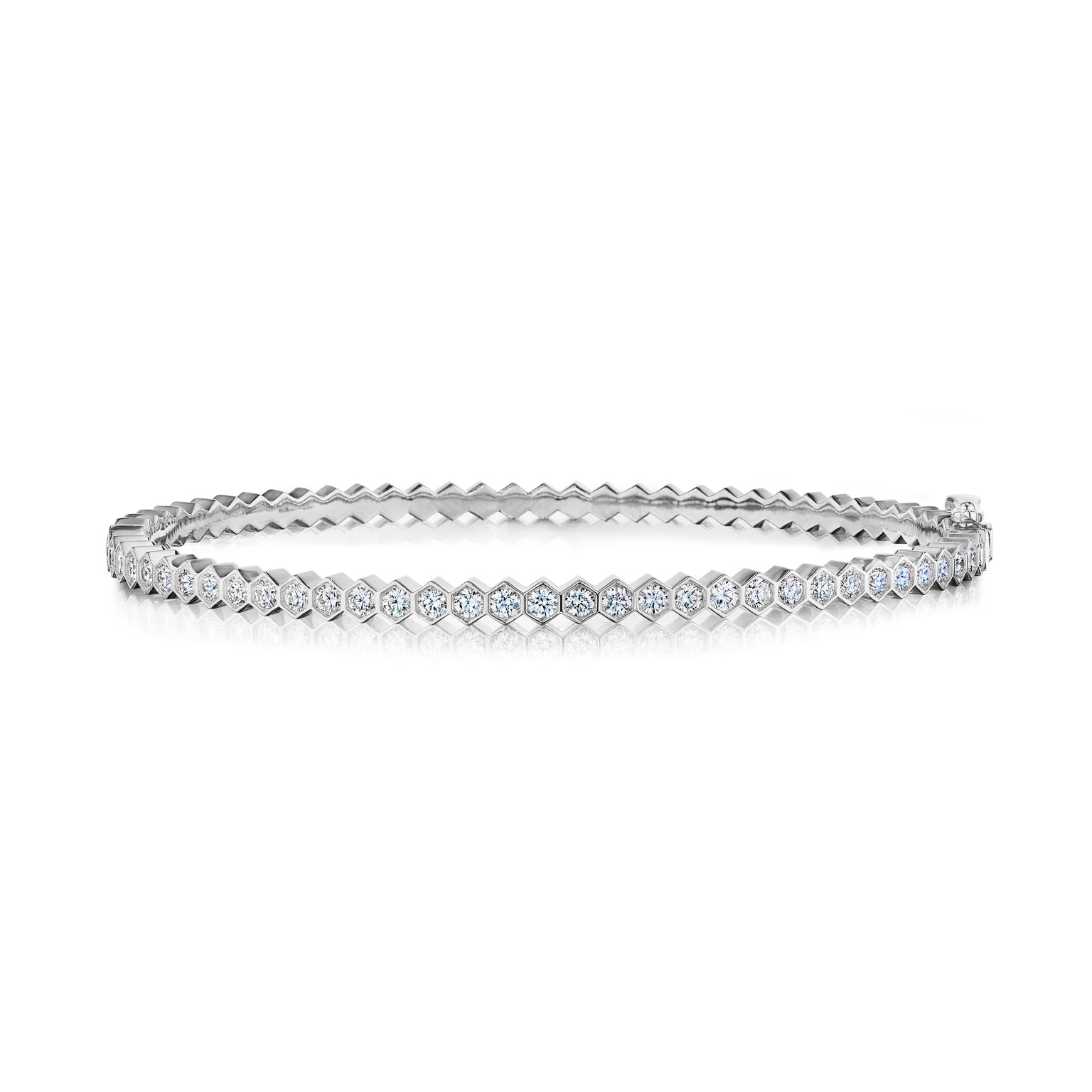 The Hexagon Bezel Set Diamond Bangle in white gold features round diamonds set in hexagonal bezels, shown on a white background.