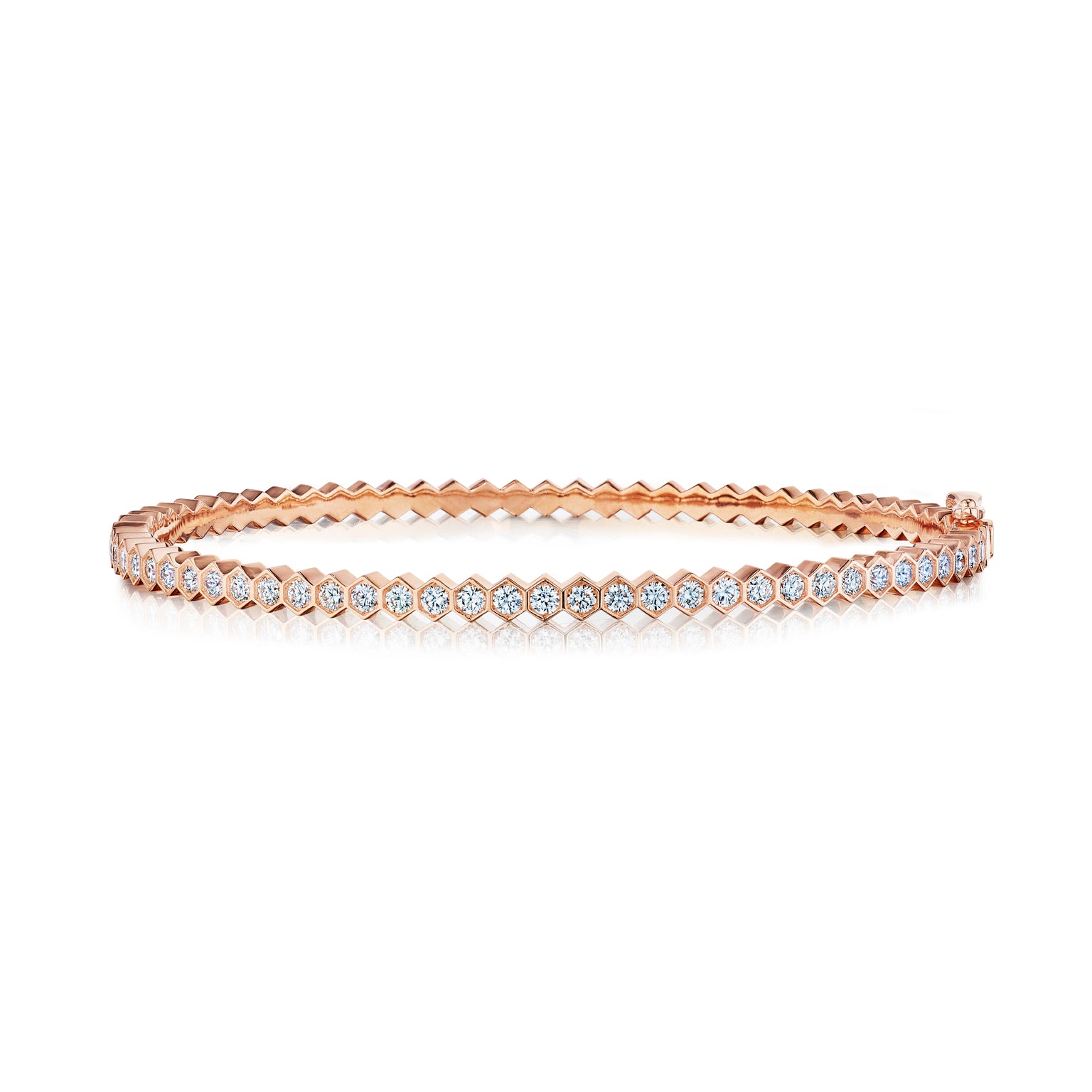The Hexagon Bezel Set Diamond Bangle showcases a single row of round white diamonds in unique hexagonal 18k gold settings, elegantly presented on a white background.