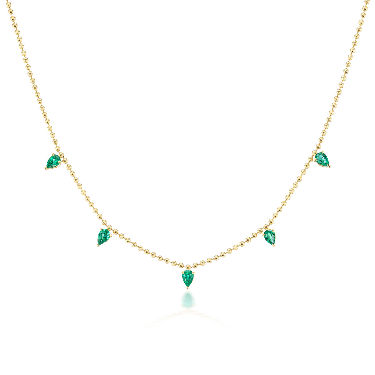 The Spike Necklace in Yellow Gold with Pear Emeralds features six teardrop emerald pendants spaced along an 18K yellow gold chain for a refined, elegant look.