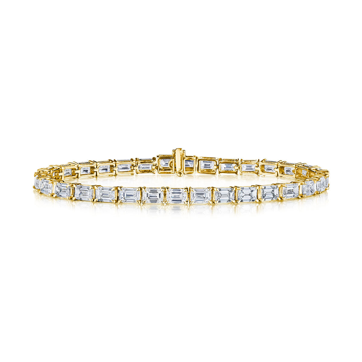 The East-West Emerald Cut Diamond Tennis Bracelet in Yellow Gold features a single row of emerald cut diamonds set in 18k yellow gold links, shown against a white background.