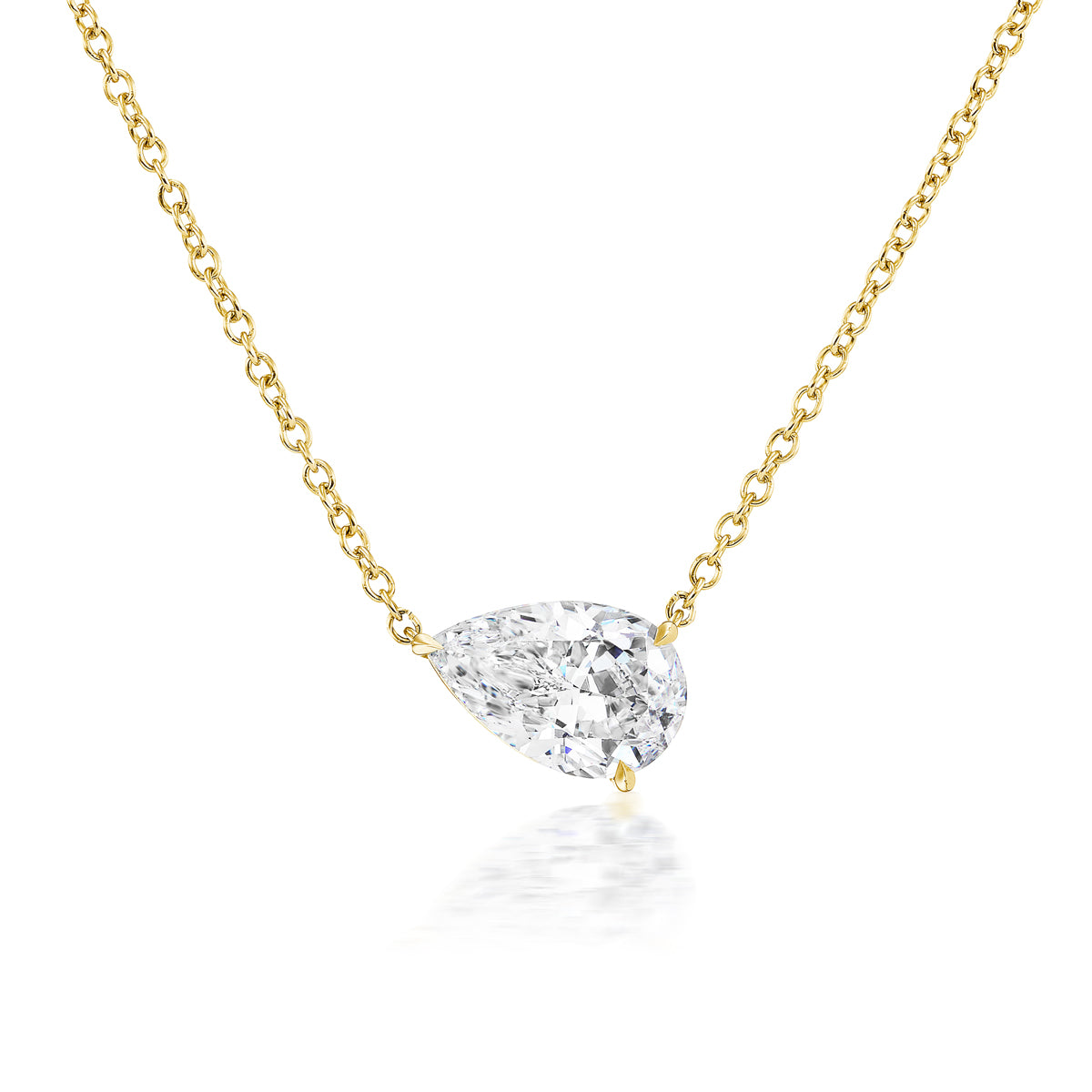 The East-West Set Pear Pendant Necklace features a single SI1 clarity pear-shaped diamond set in minimalist 18K yellow gold, displayed against a white background.
