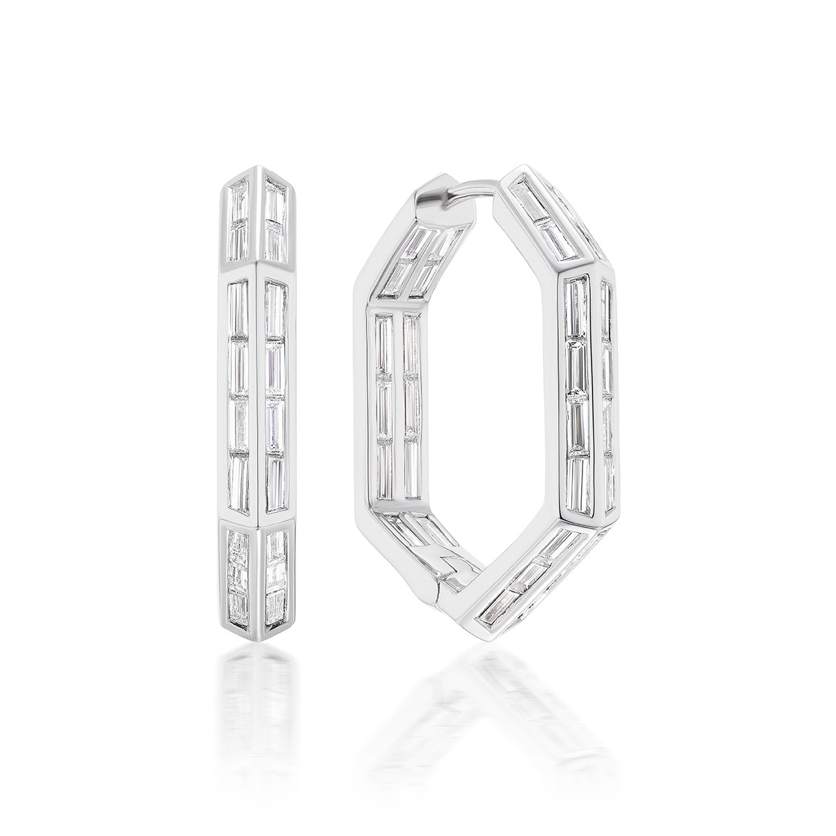 The Chrysler Hoops with Baguette Diamonds are hexagonal white metal earrings set with multiple rectangular-cut clear gemstones in a bold geometric pattern, shown on a white background.