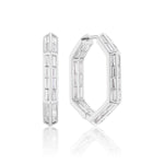 The Chrysler Hoops with Baguette Diamonds are hexagonal white metal earrings set with multiple rectangular-cut clear gemstones in a bold geometric pattern, shown on a white background.