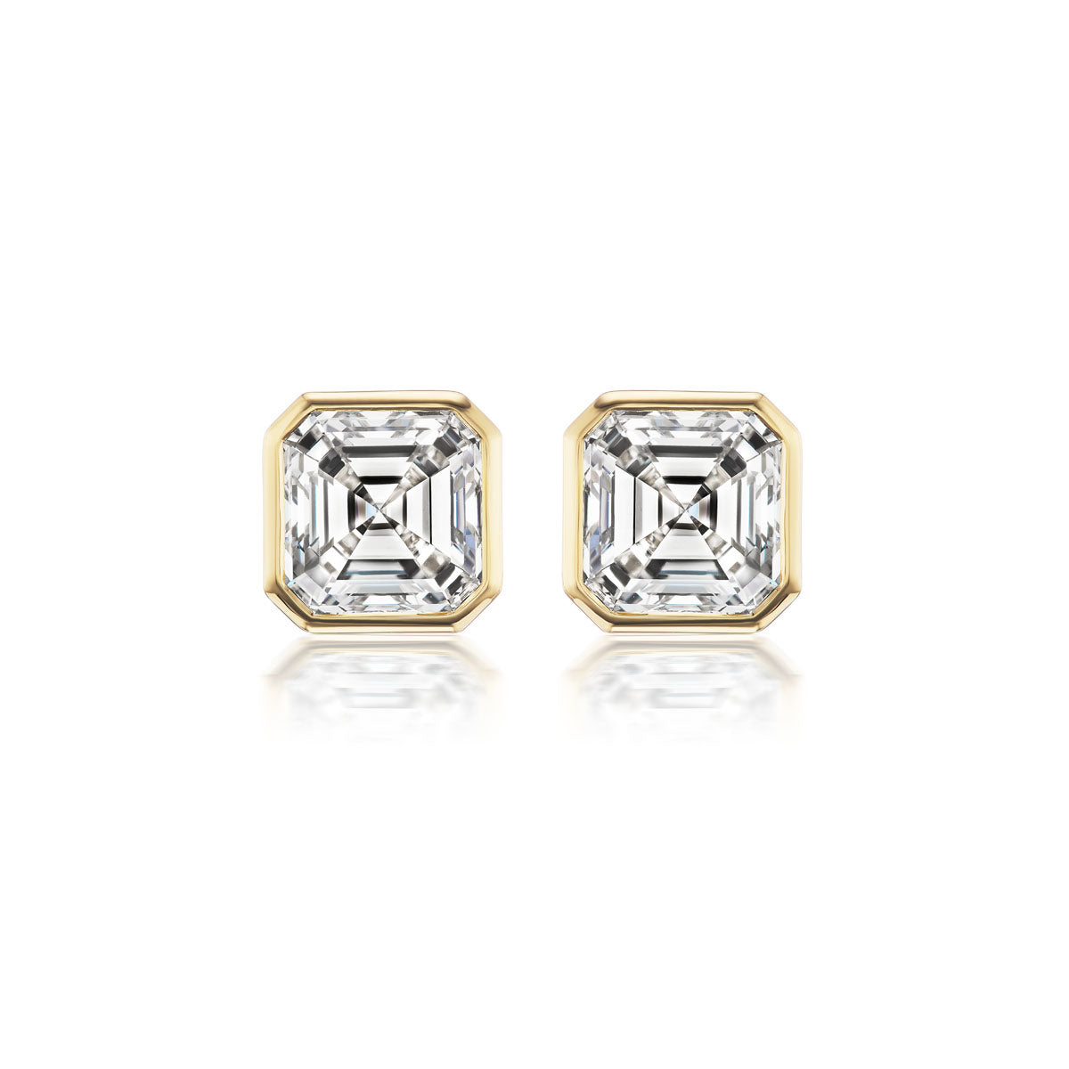 The Bezel Set Asscher Cut Diamond Studs feature square SI1 diamonds totaling 1.50ct, set in yellow gold bezels with step-cut facets, shown against a white background.