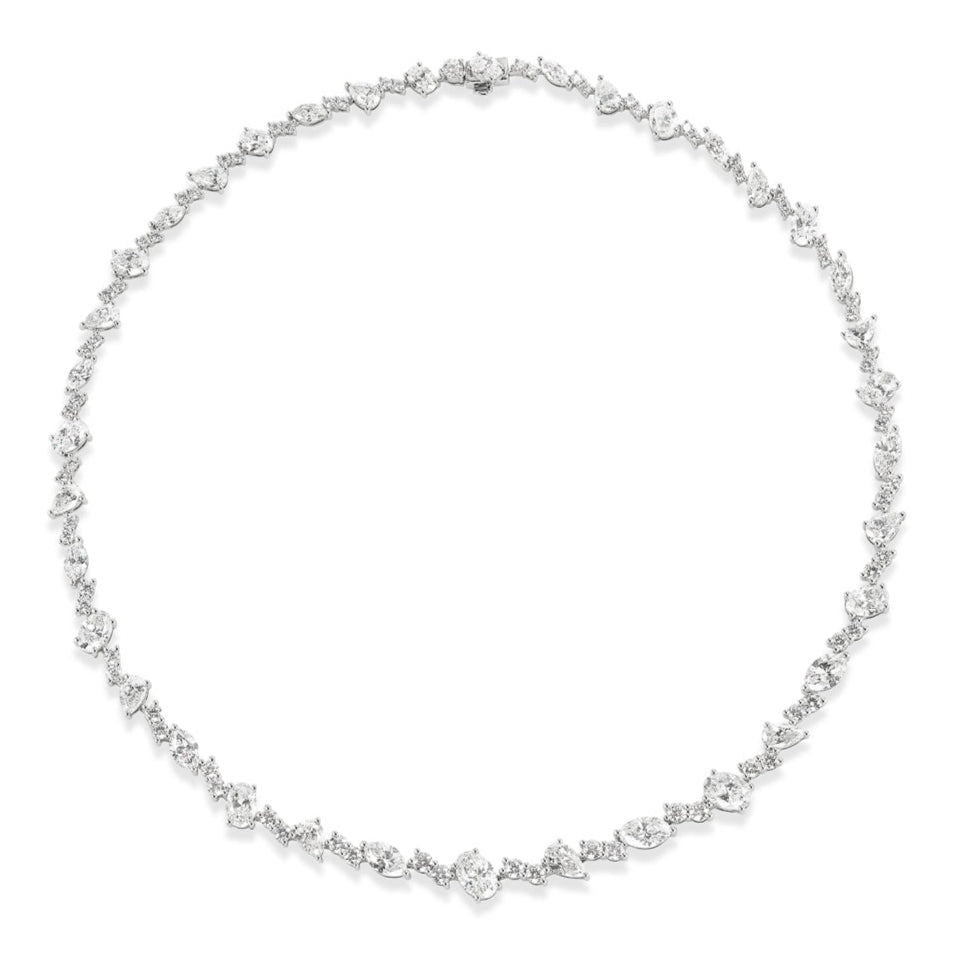 The Mixed Shape Diamond Tennis Necklace in White Gold showcases white diamonds of various shapes set closely together in 18K white gold, creating a continuous, symmetrical loop for a timeless look.