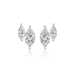 The Duo Studs in White Gold with Marquise Diamonds feature a large marquise diamond paired with a smaller pear-shaped diamond, both set in 18K white gold against a plain white background.