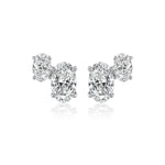 The Duo Studs in White Gold with Oval Diamonds feature two vertically aligned, sparkling oval-cut diamonds set in 18K white gold on each earring, shown against a white background.