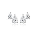 The Duo Studs in White Gold with Pear Diamonds feature two pear-shaped clear diamonds set in 18K white gold, elegantly displayed on a white background.