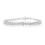 The Graduated Hexagon Bezel Set Diamond Tennis Bracelet in 18K white gold features hexagonal links, each with a round brilliant diamond, shown against a white background.