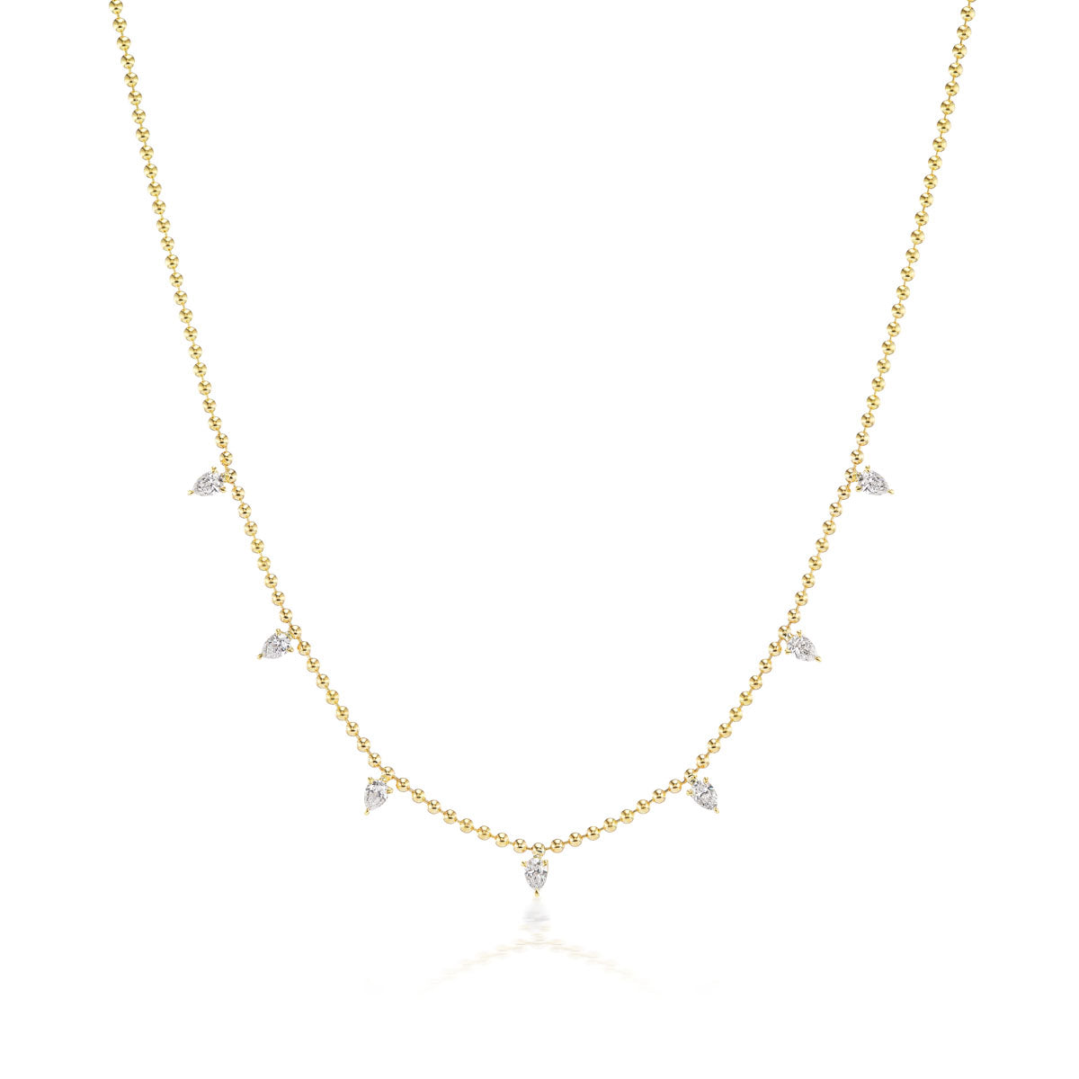The Spike Ball Chain Necklace with Pear Diamonds is crafted in 18K gold, featuring small, evenly spaced pear-shaped diamonds along the lower front section, and is shown on a plain white background.
