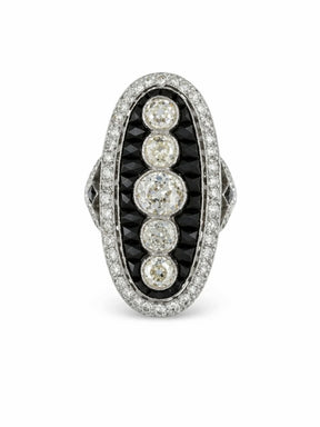 The Onyx and Diamond Ring showcases an elongated oval design with five old mine-cut diamonds in the center, bordered by calibré-cut onyx and a halo of small white diamonds, all set in platinum in classic 1930s style.