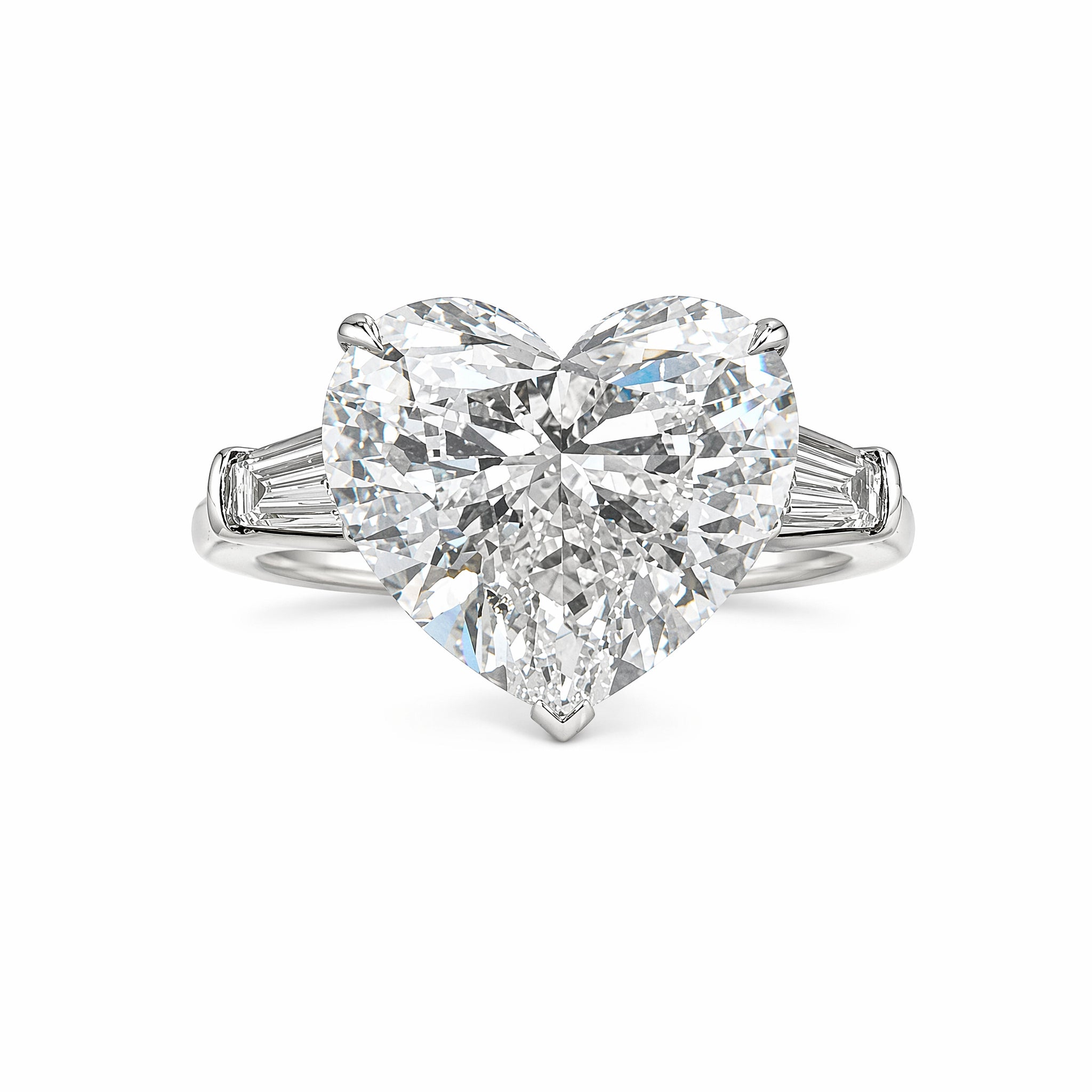 A Heart Shape Diamond Engagement Ring with bezel set tapered baguette side stones, showcased on a platinum band against a white background.