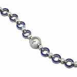 The Cartier Art Deco Sapphire and Diamond Watch features a vintage 1920s-inspired bracelet with blue and silver links, embedded diamonds, a sapphire accent, and a small round central watch face.