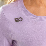A person wears a light purple knit top with the Antique Diamond and Enamel Snake Pin near the left collar. Only their upper torso and part of their blond hair are visible.