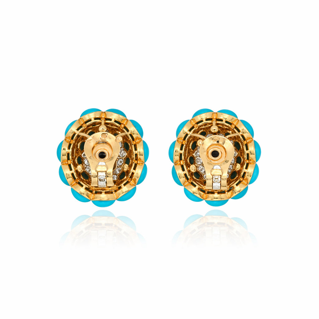 A pair of Van Cleef & Arpels Sapphire, Turquoise, and Diamond earclips displayed against a white background.