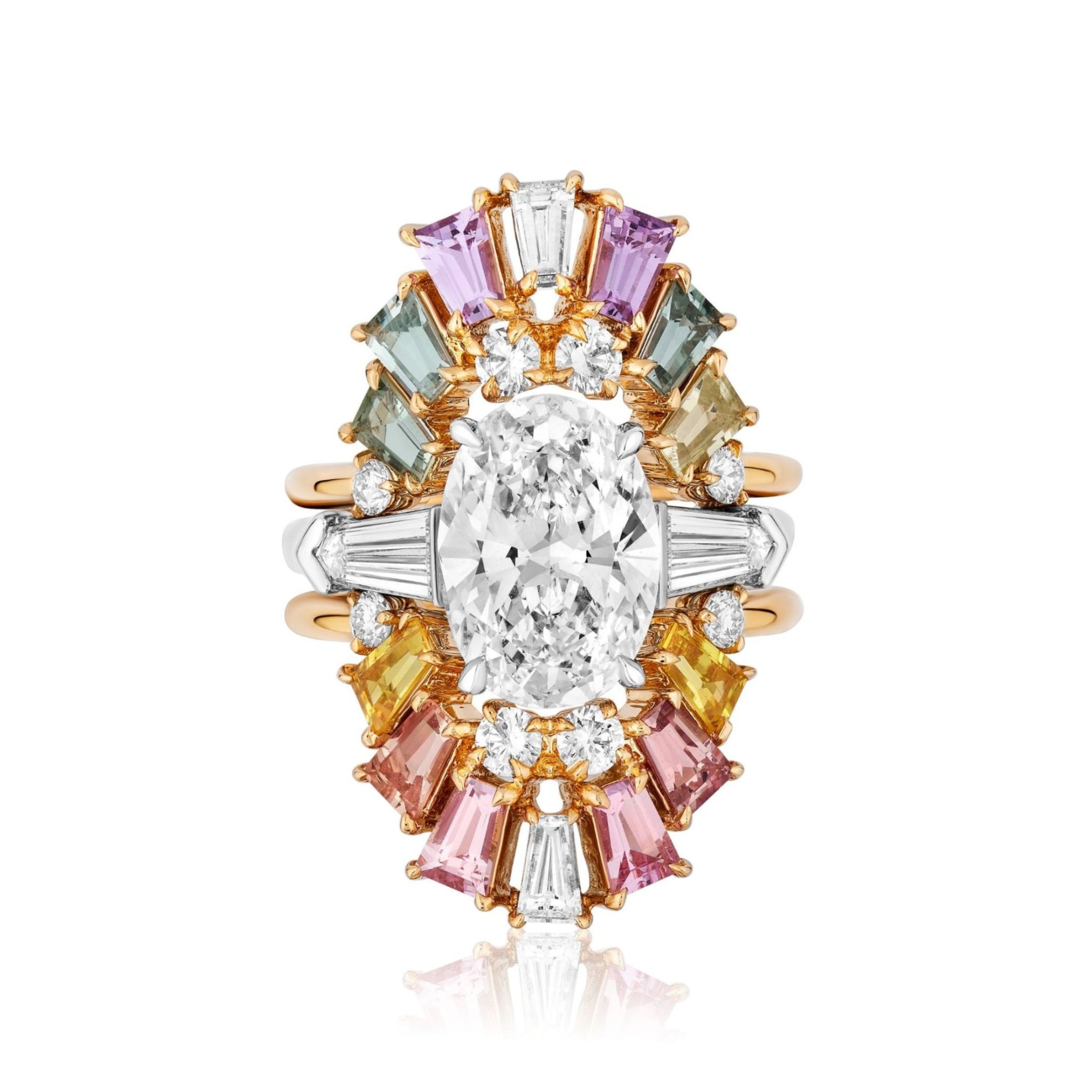 A dazzling Multicolor Tapered Baguette Sapphire and Round Diamond Ring Jacket in Yellow Gold, featuring a striking oval center diamond encircled by vibrant tapered baguette sapphires and sparkling round diamonds in a stunning double halo design, set on an elegant yellow gold band.