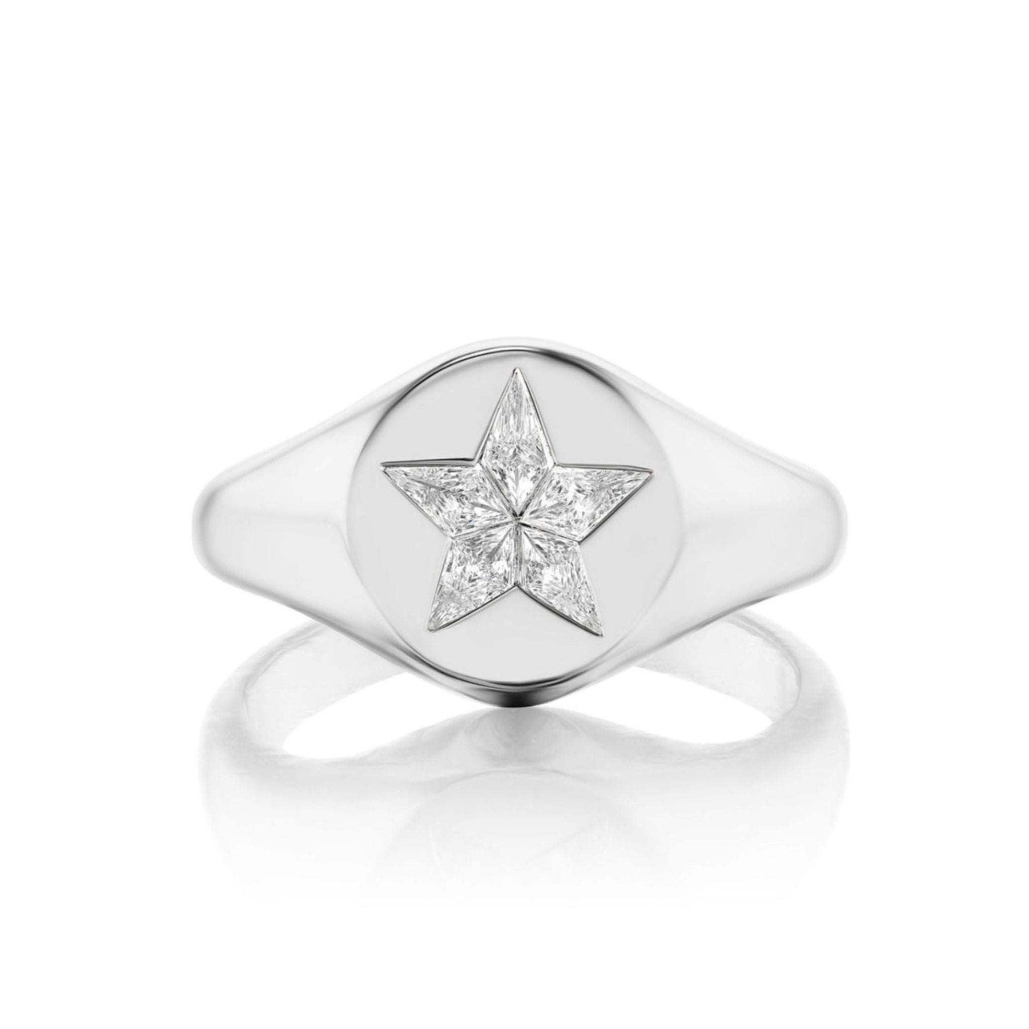 A refined white gold Celestial Star Signet Ring with a round face, showcasing a five-pointed star design inlaid with small, clear kite-shaped diamonds against a white background.