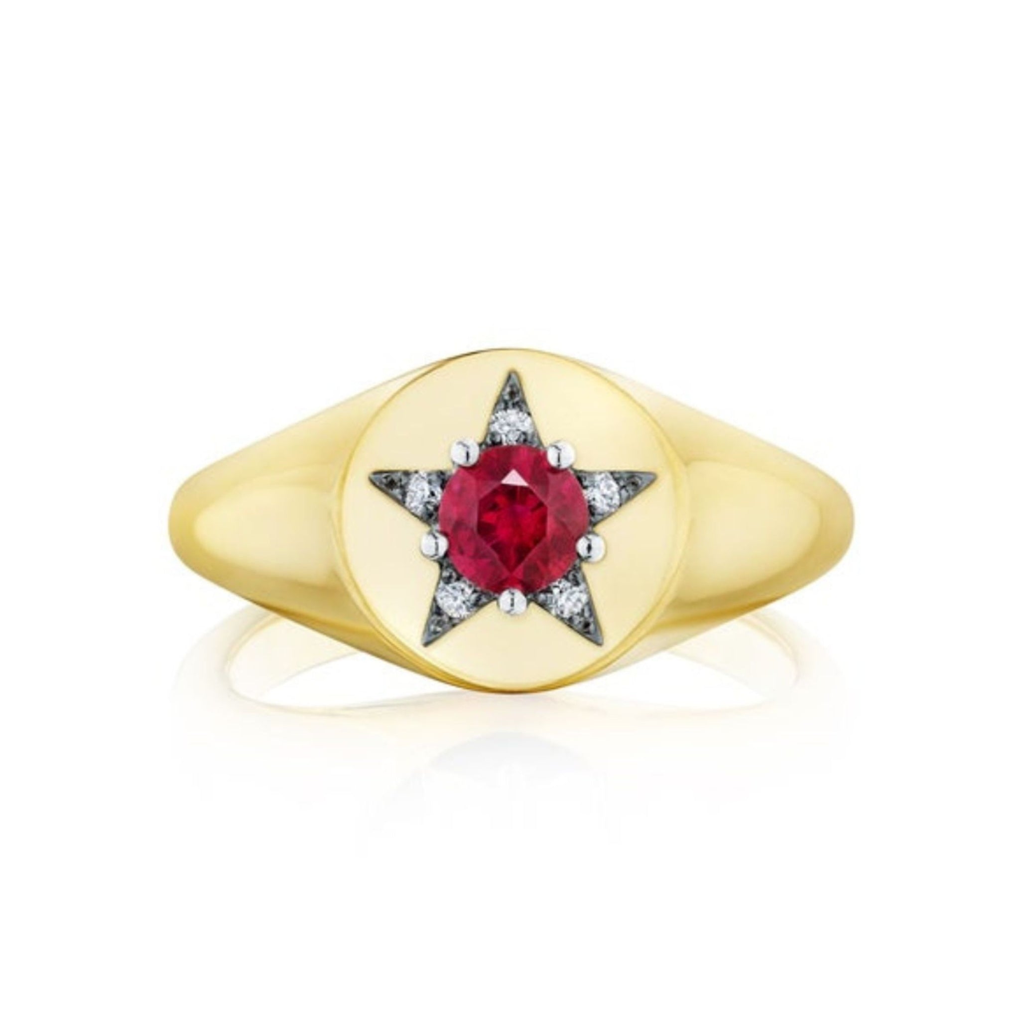 The America250 Star Signet Ring in Yellow Gold and Platinum is handcrafted in New York City, featuring a round red gemstone set at the center of a six-pointed star design and accented with small clear stones on each point of the star.