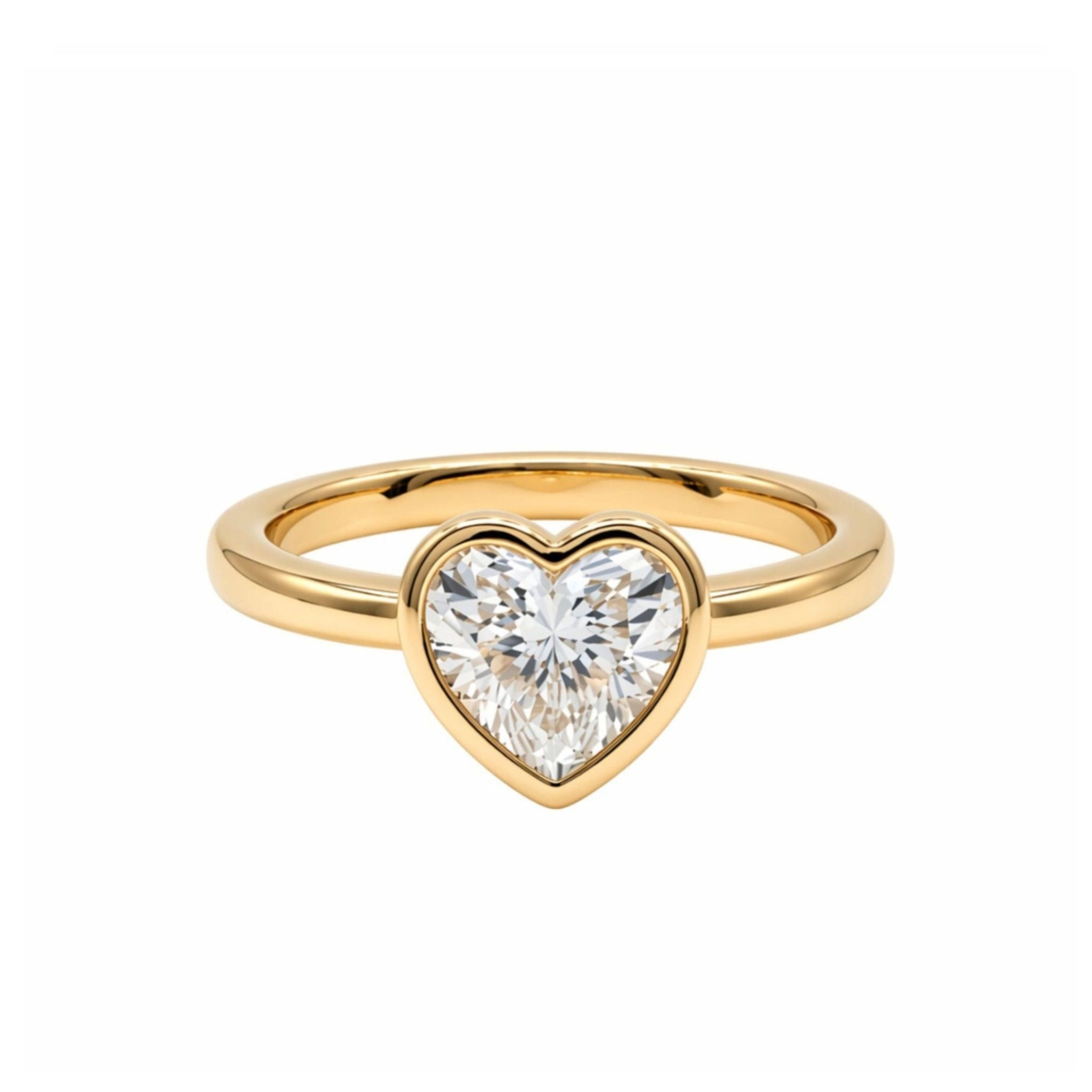 The Bezel Set Heart Shape Diamond Engagement Ring in Yellow Gold is displayed against a plain white background.