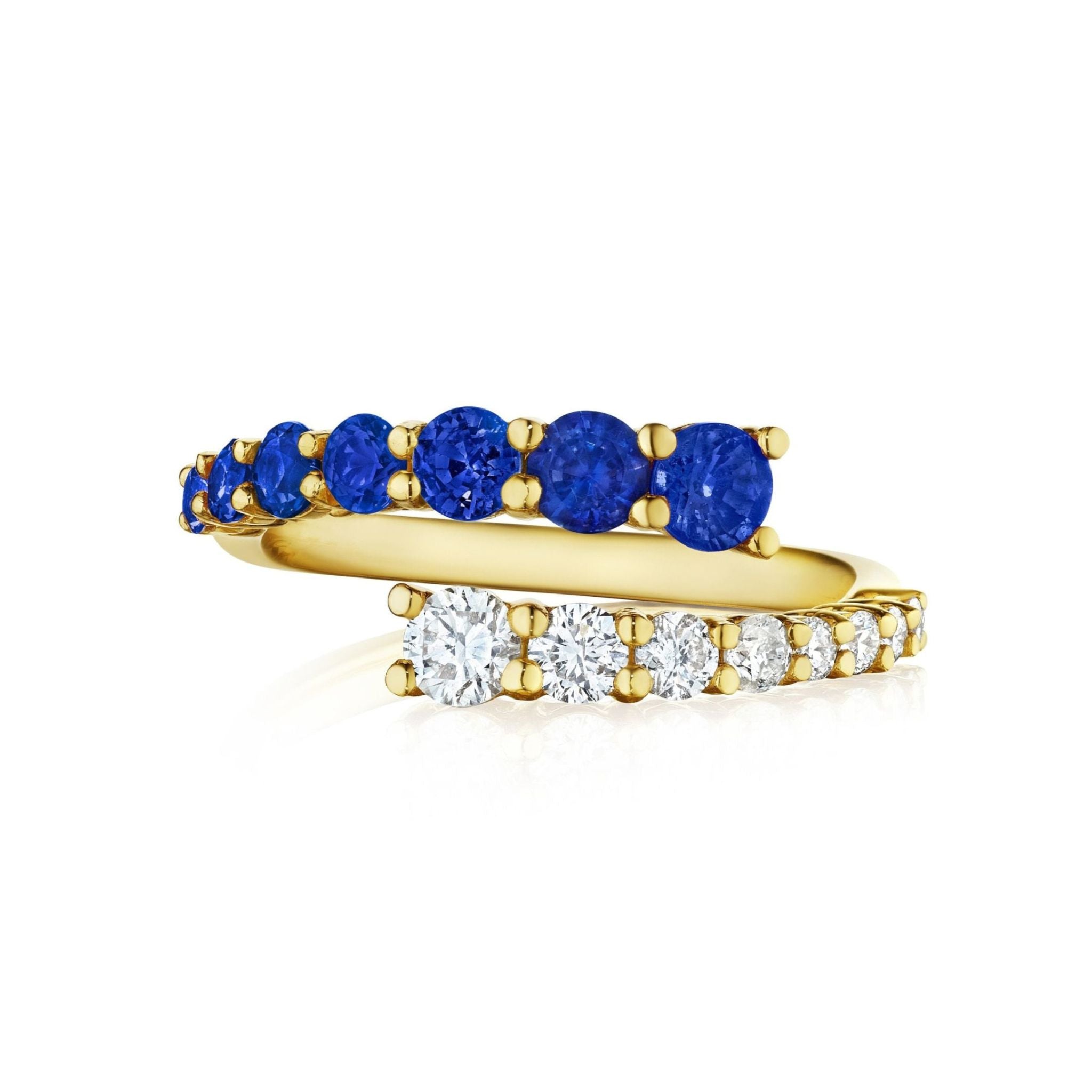 The Open Space Ring with Round Diamonds and Blue Sapphires in Yellow Gold features two partially overlapping gold bands—one set with round blue sapphires, the other with round white diamonds—each prong-set and elegantly displayed on a white background.